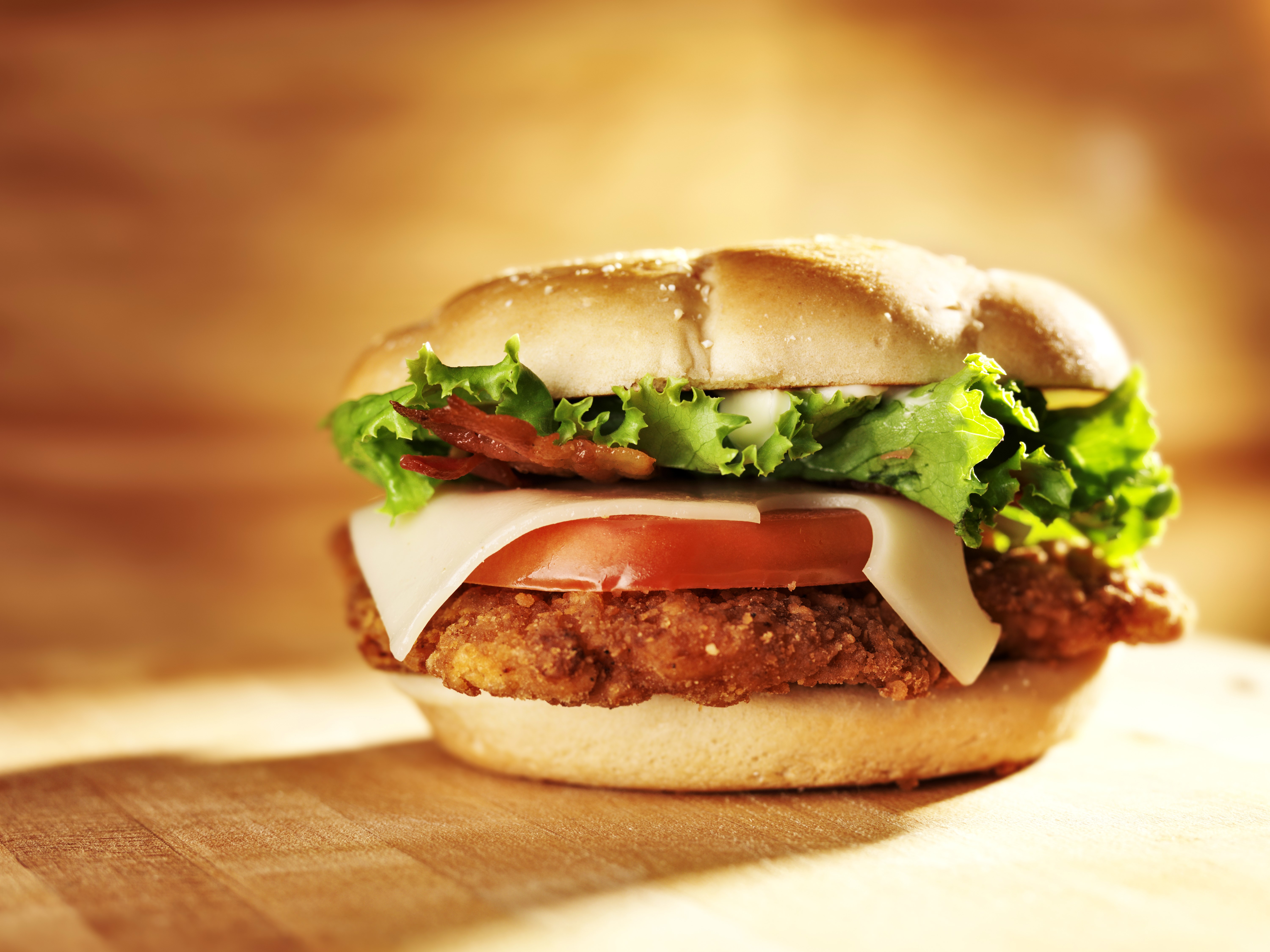 Chicken sandwich with cheese, lettuce, tomato, and bacon HD Wallpaper
