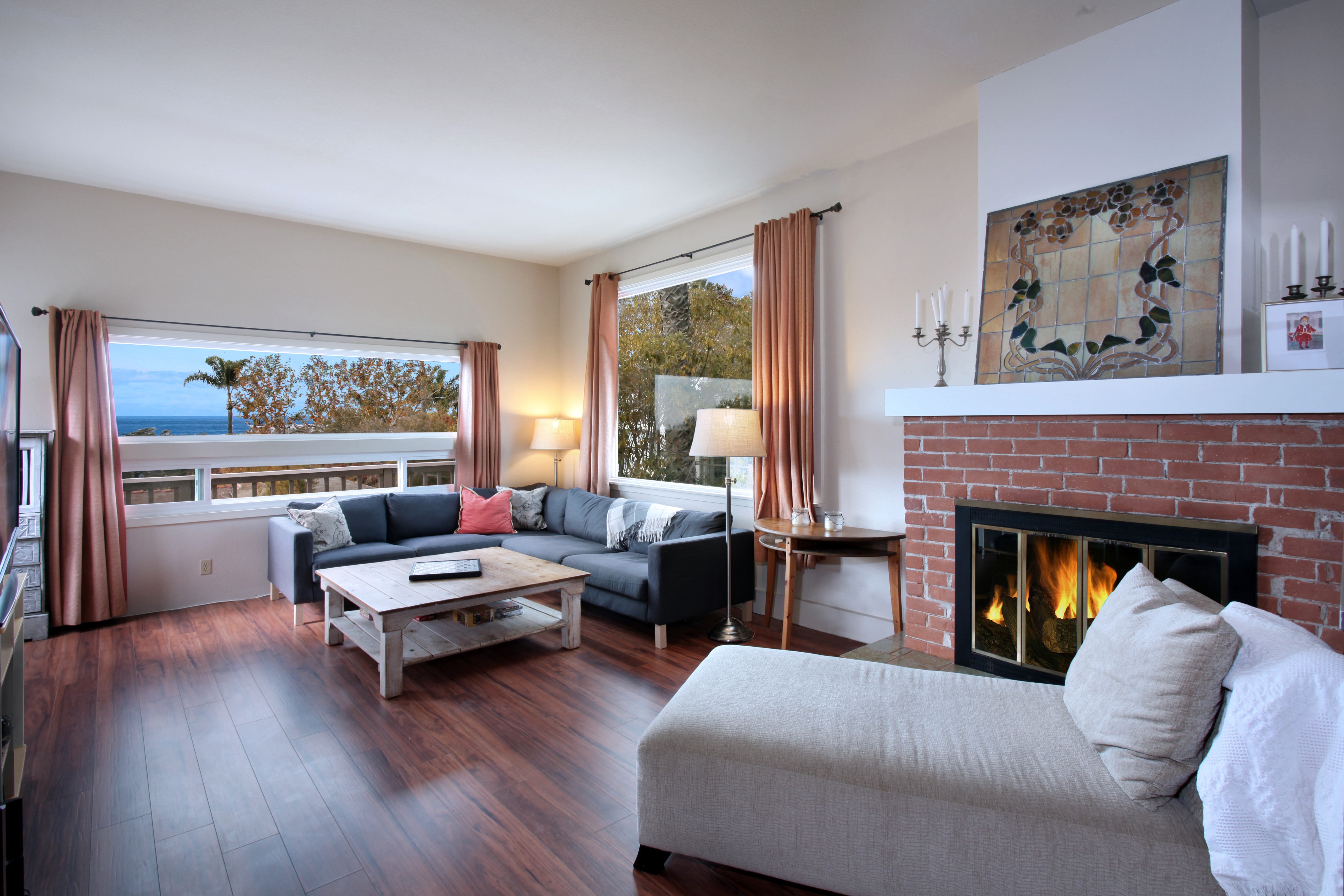 Living room with fireplace and ocean view HD Wallpaper