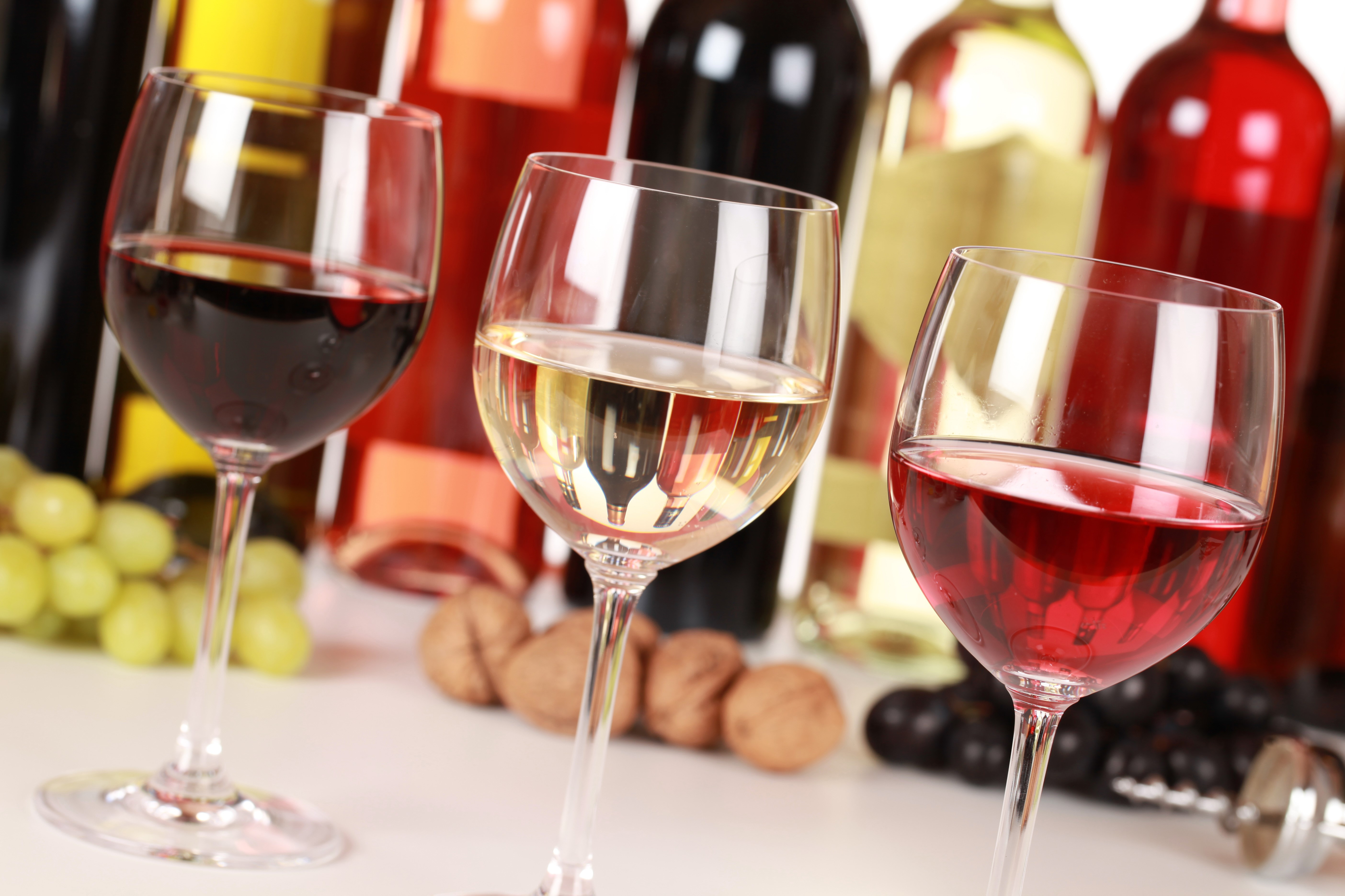 Wine bottles and glasses with grapes and walnuts HD Wallpaper