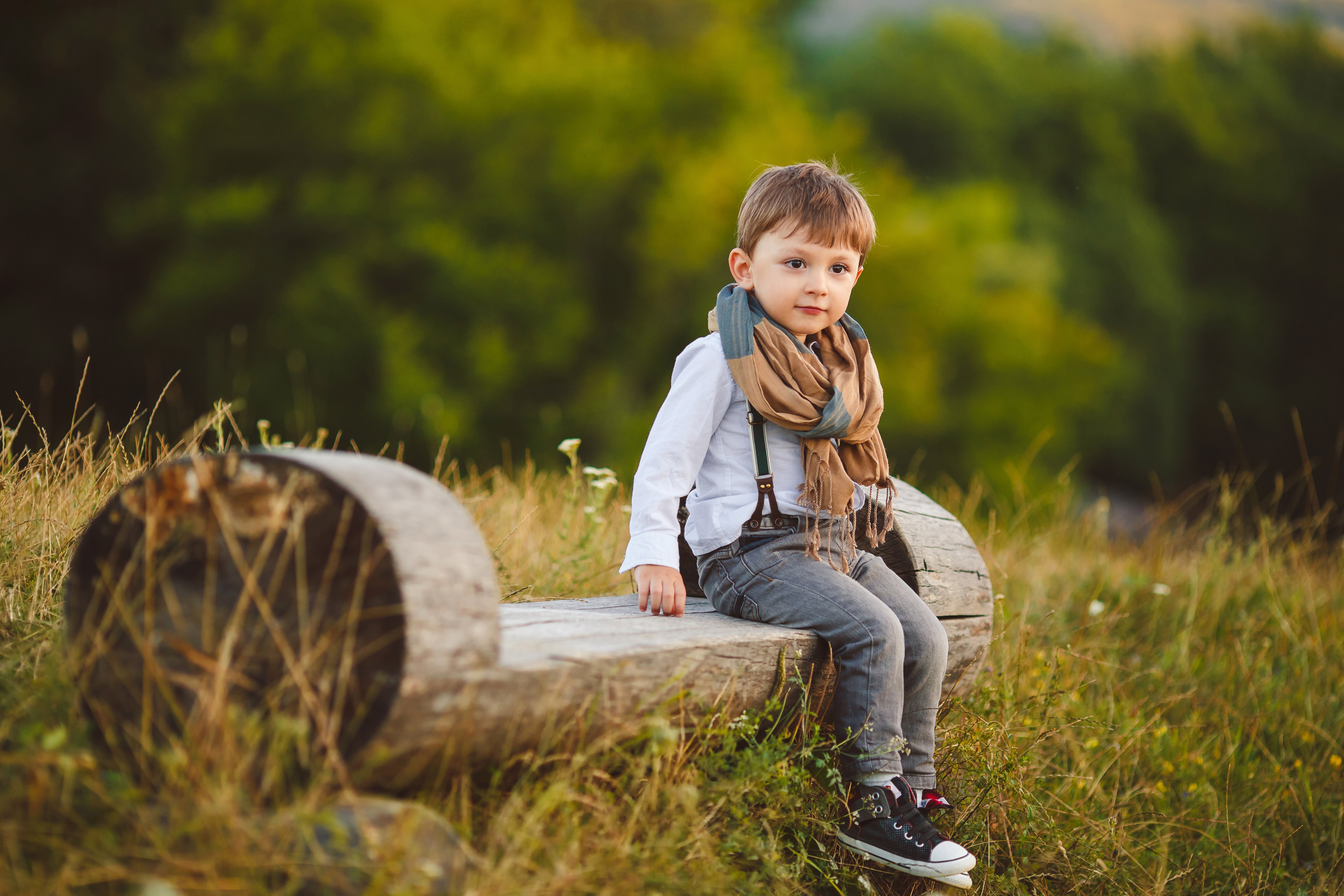 Boy in Jeans and Scarf Sitting on a Log Bench HD Wallpaper