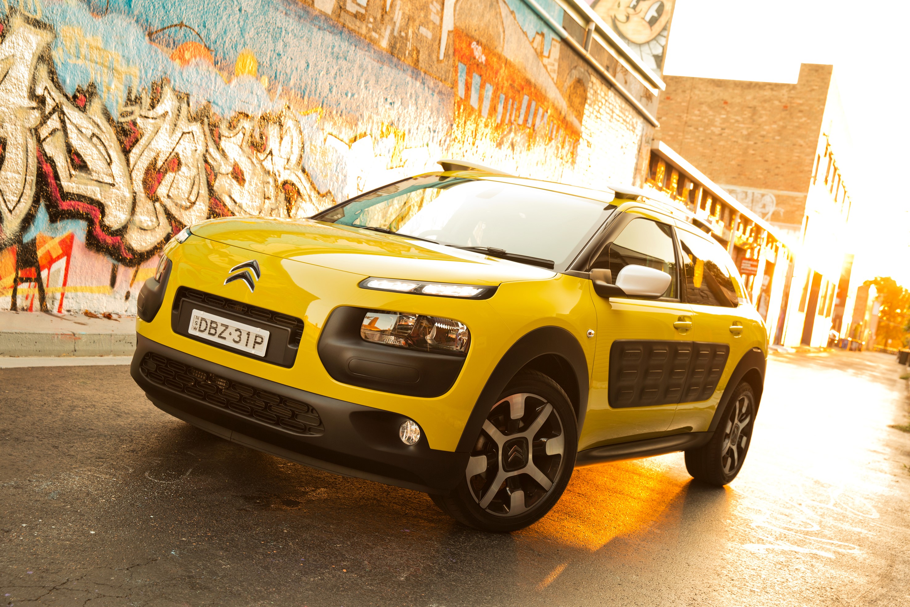 Yellow Citroen C4 Cactus parked near graffiti wall HD Wallpaper