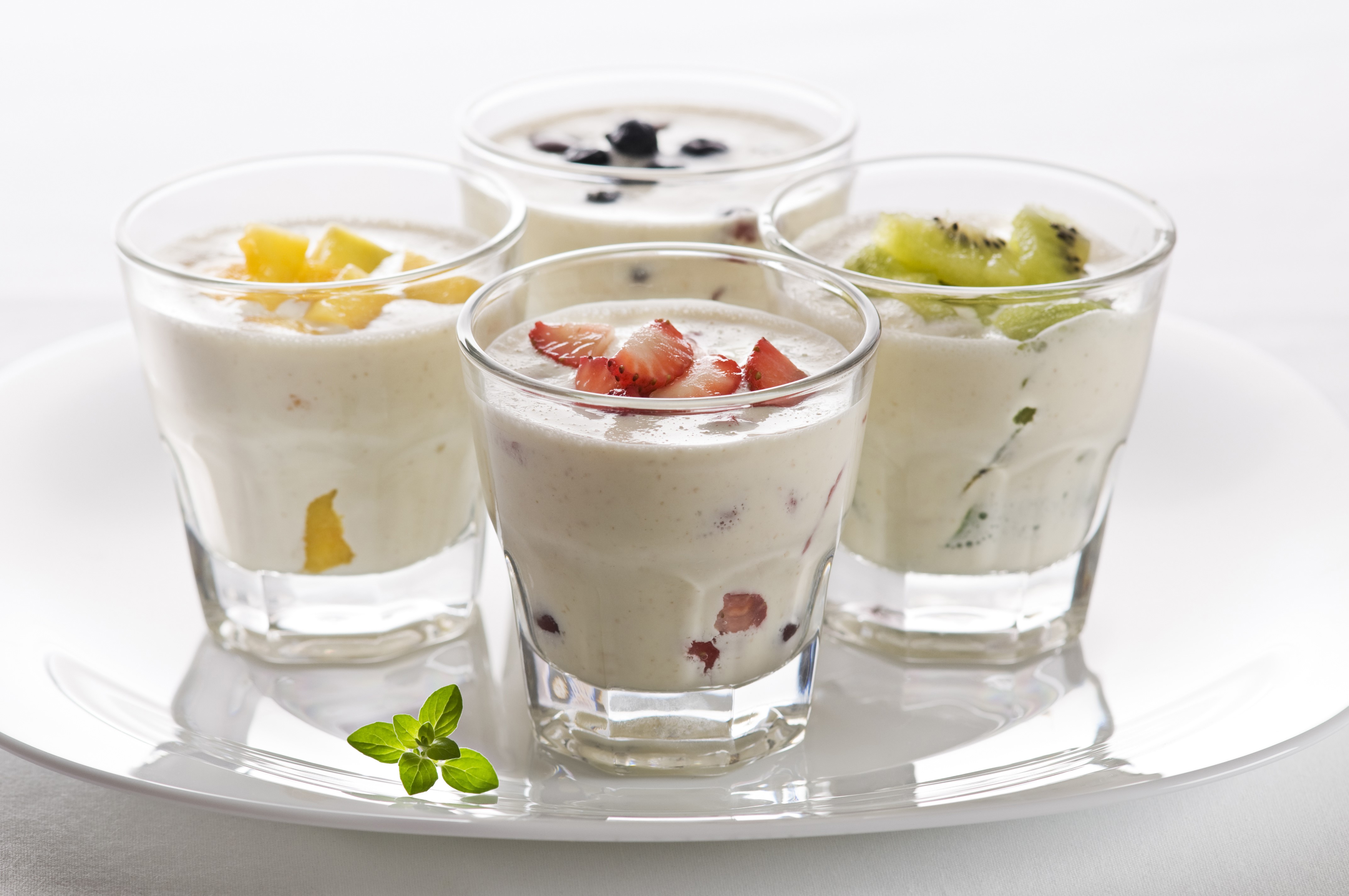 Four glasses of fruit yogurt on a plate HD Wallpaper