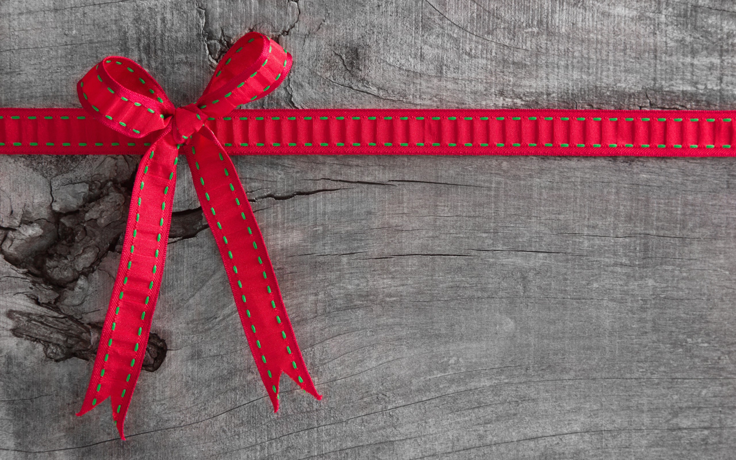 Red ribbon bow on wooden background HD Wallpaper