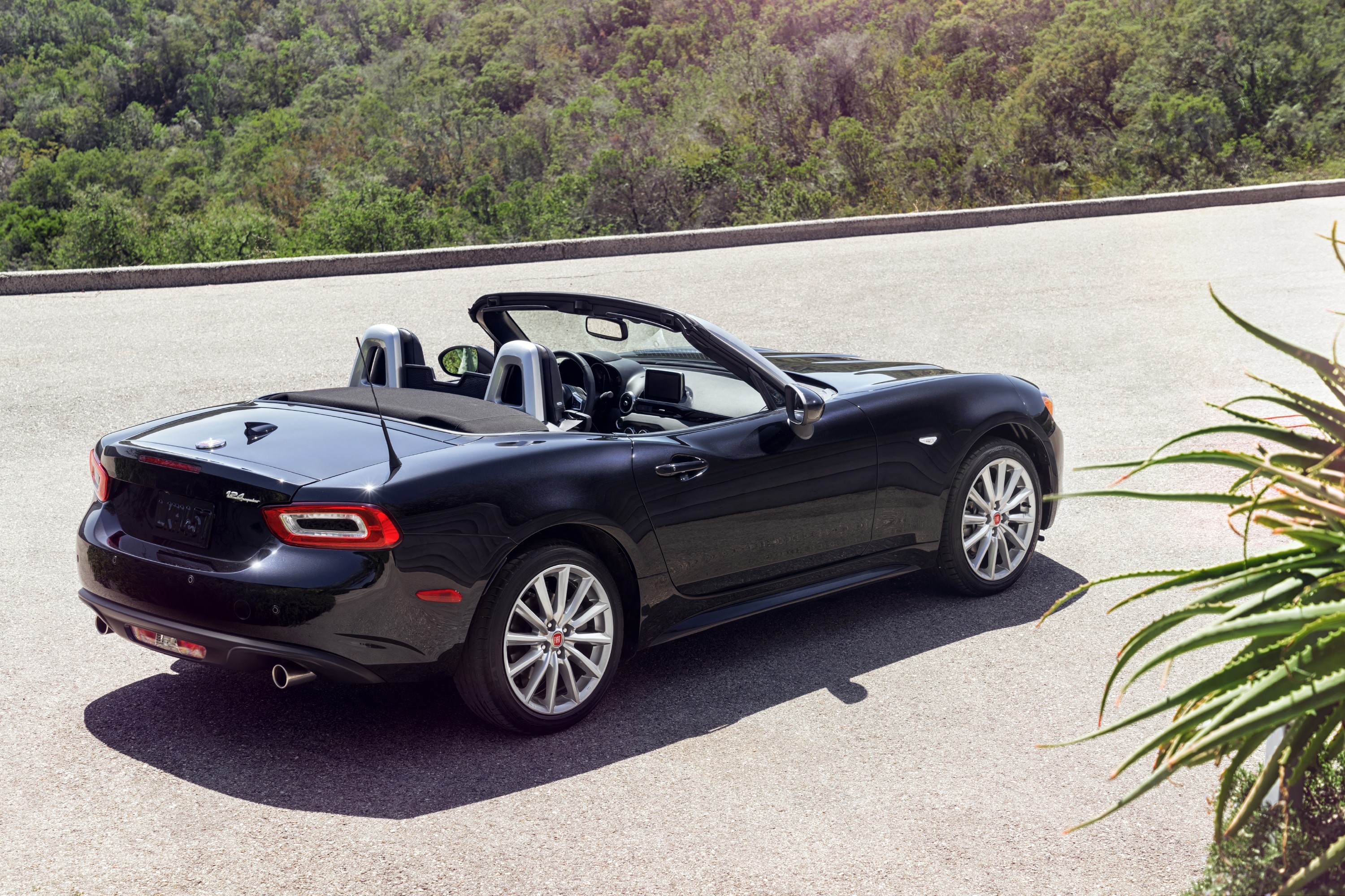 Black Fiat 124 Spider convertible parked on a road HD Wallpaper