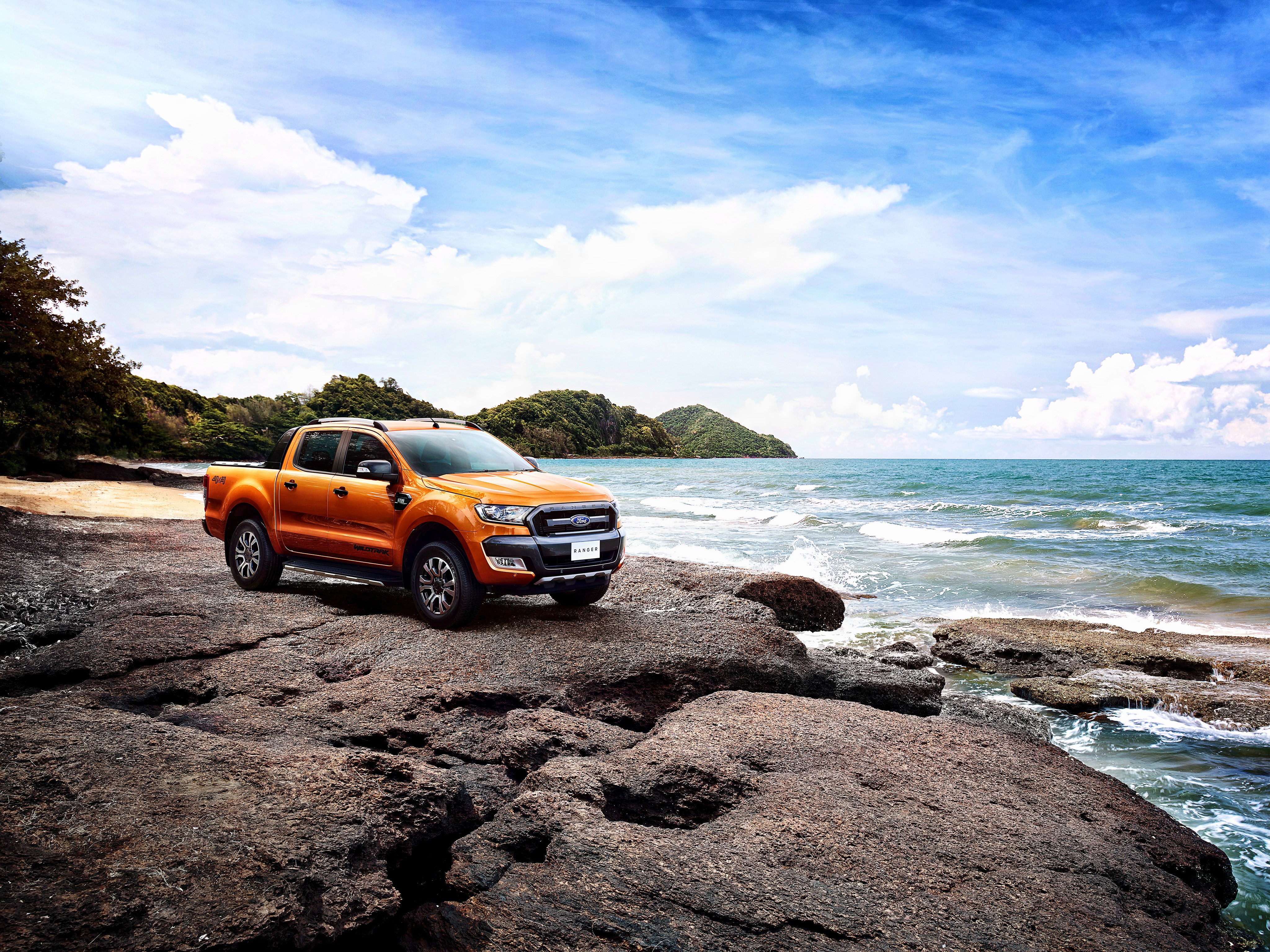 Orange Ford Ranger Wildtrak on a rocky beach HD Wallpaper