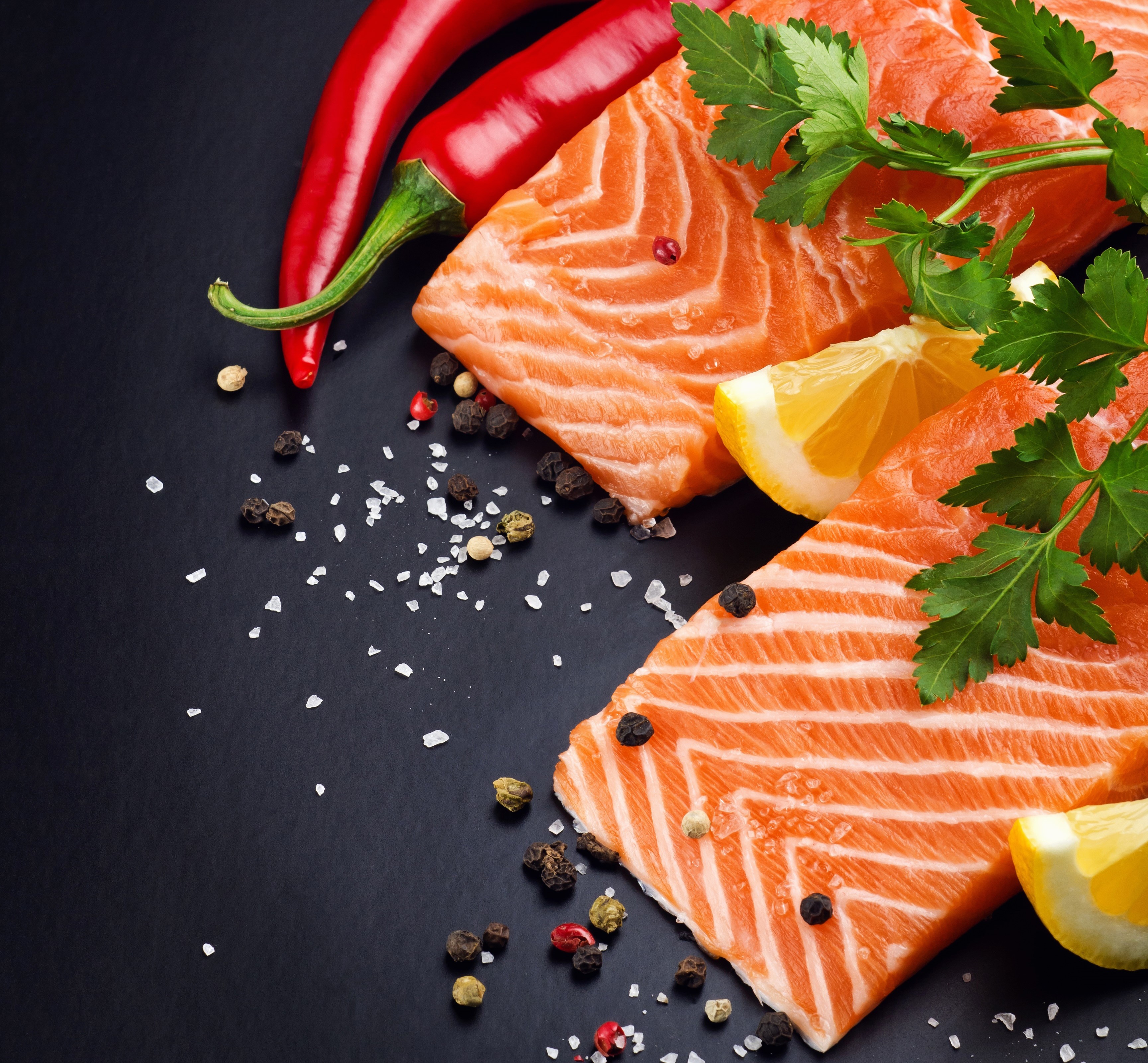 Salmon fillets with chili peppers, lemon, and spices HD Wallpaper