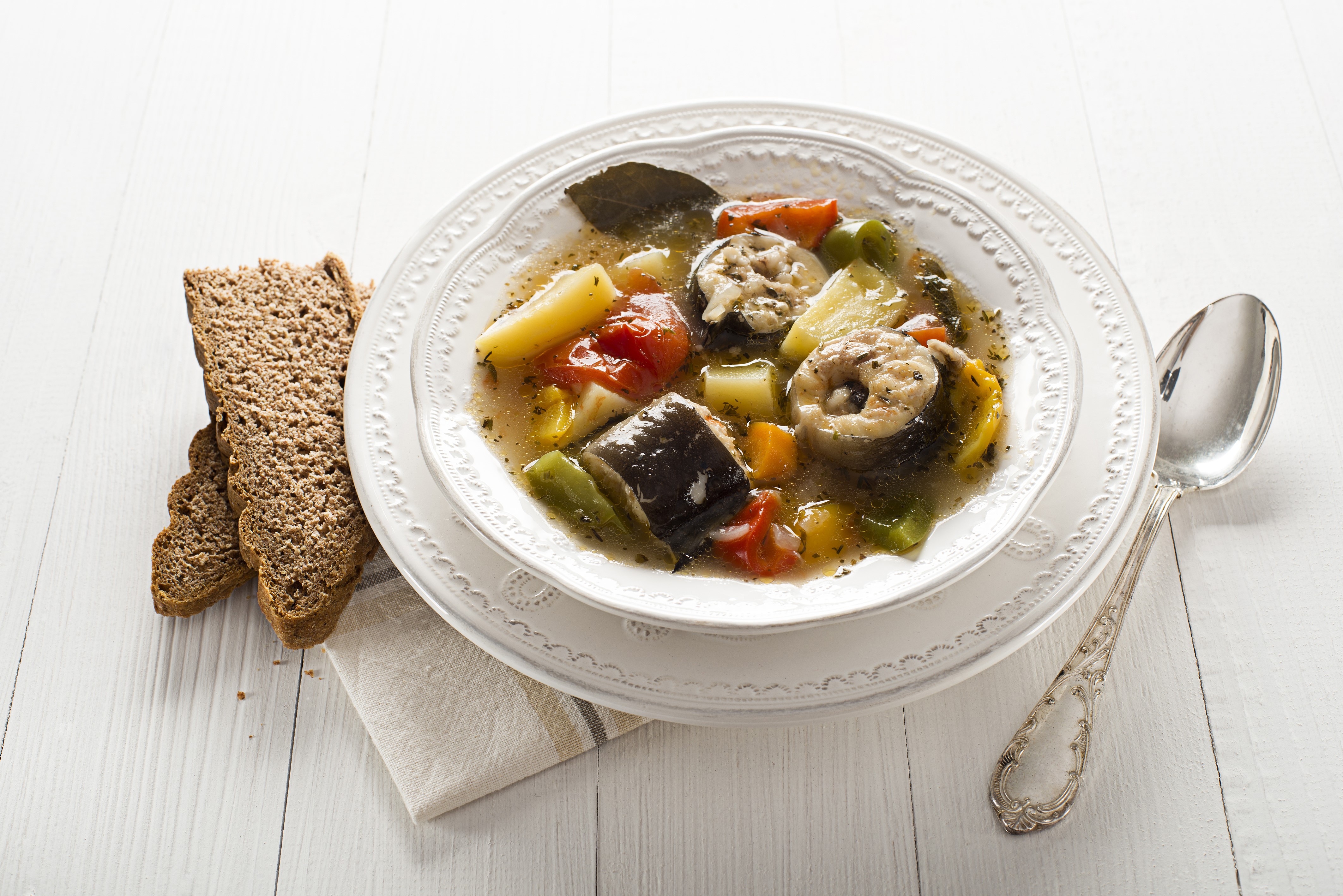 Fish soup with vegetables and bread on a plate with a spoon HD Wallpaper