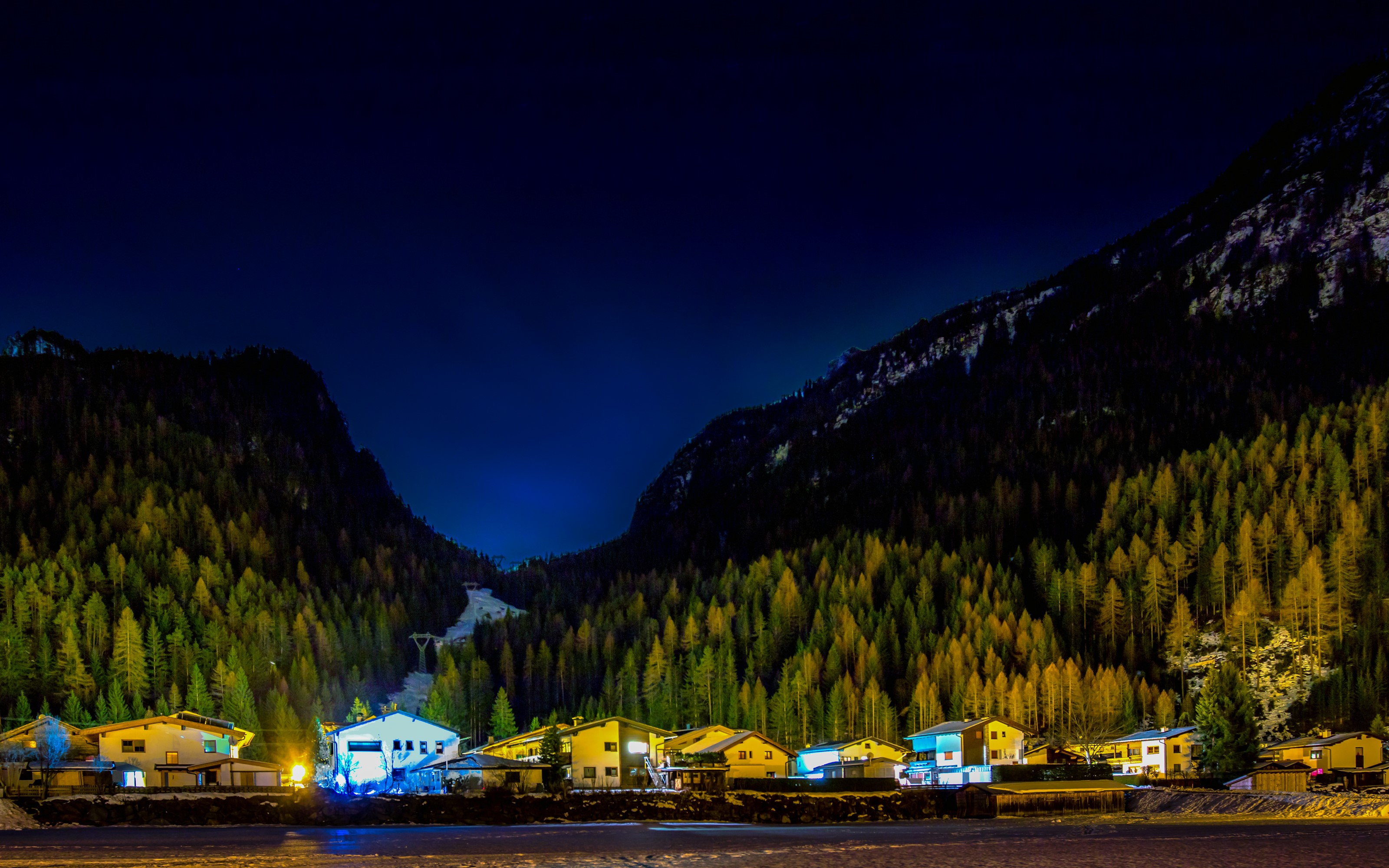 Houses in a mountain valley at night HD Wallpaper
