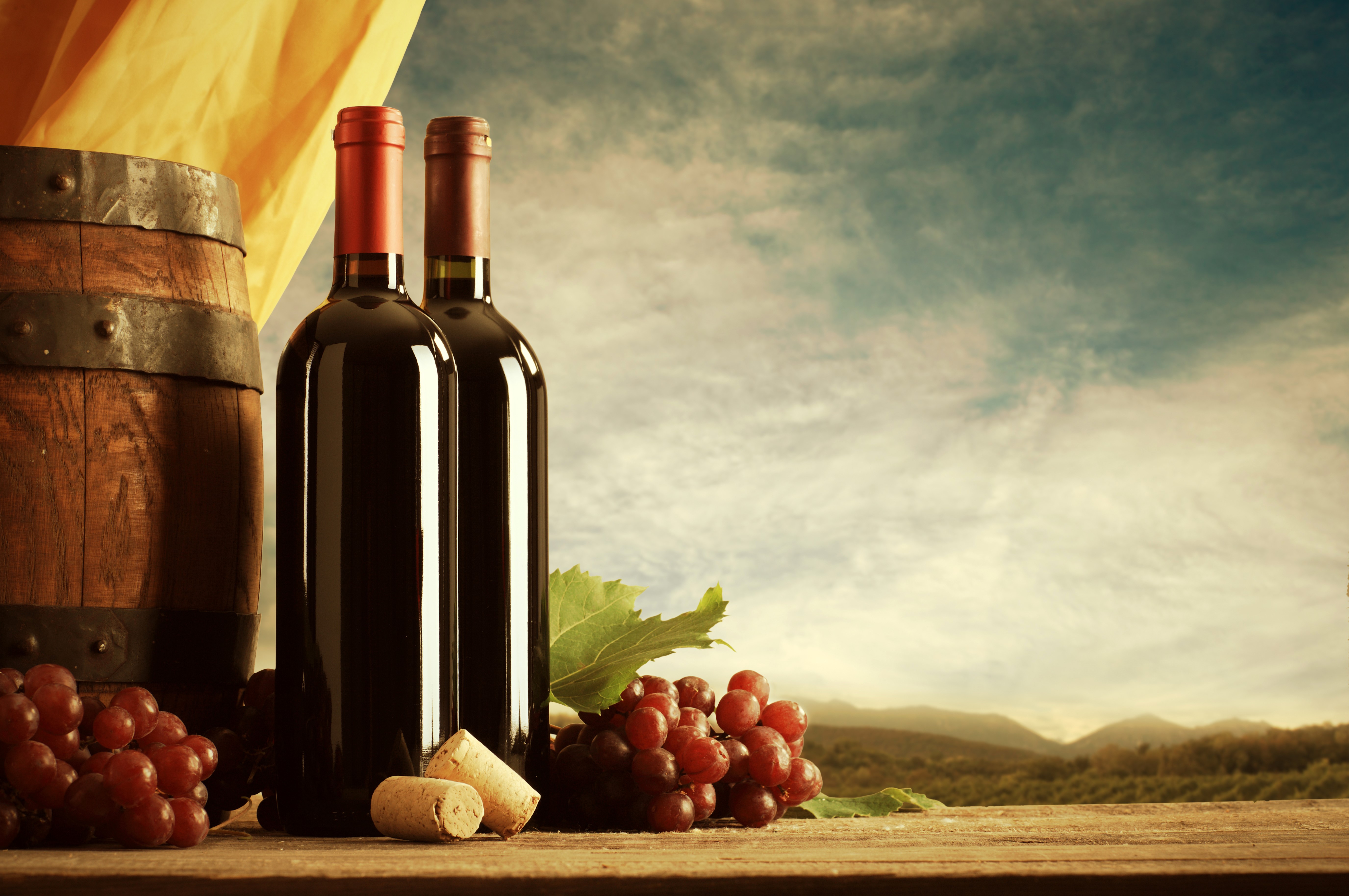 Wine bottles and grapes with a barrel HD Wallpaper
