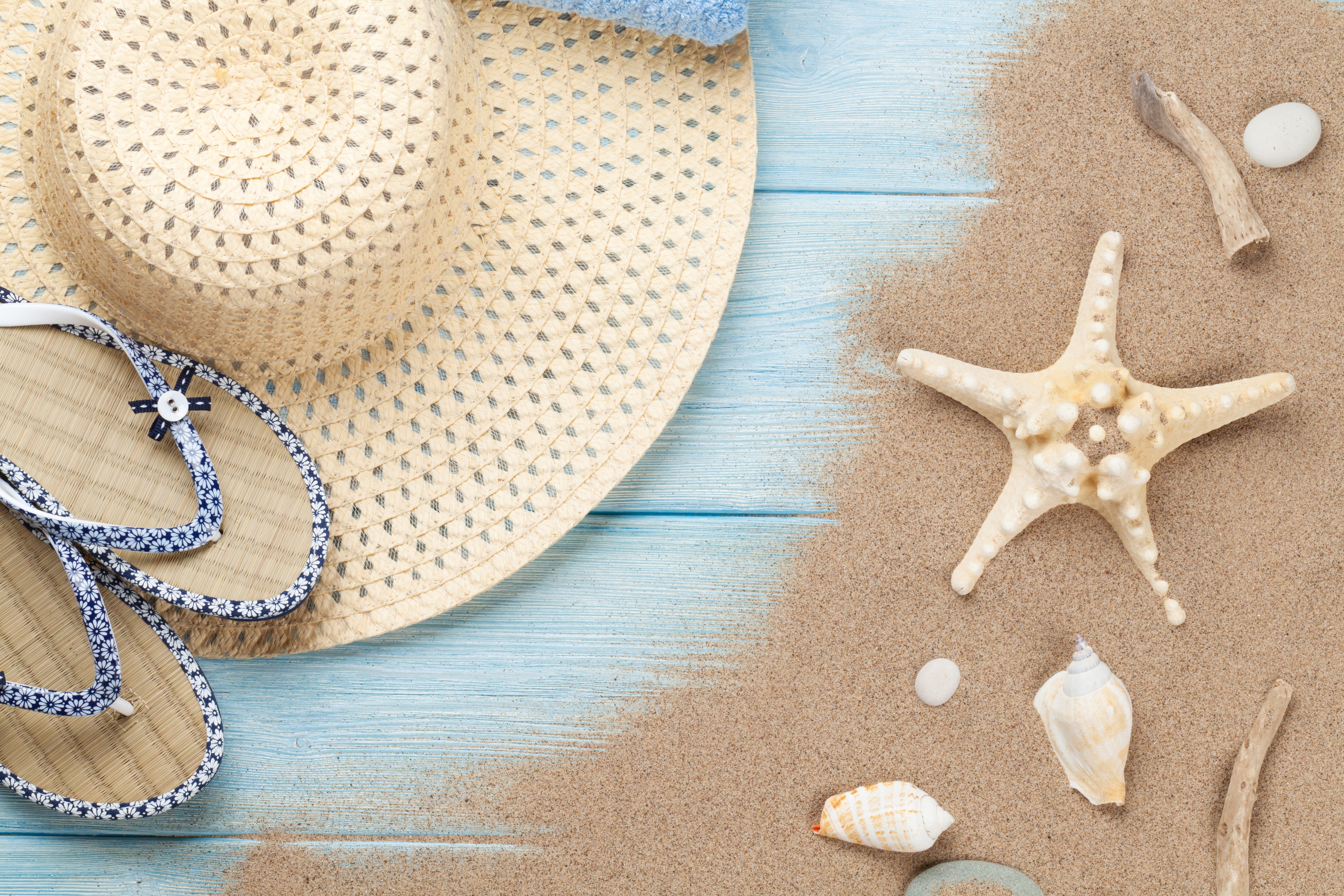 Straw hat and flip-flops on a beach HD Wallpaper