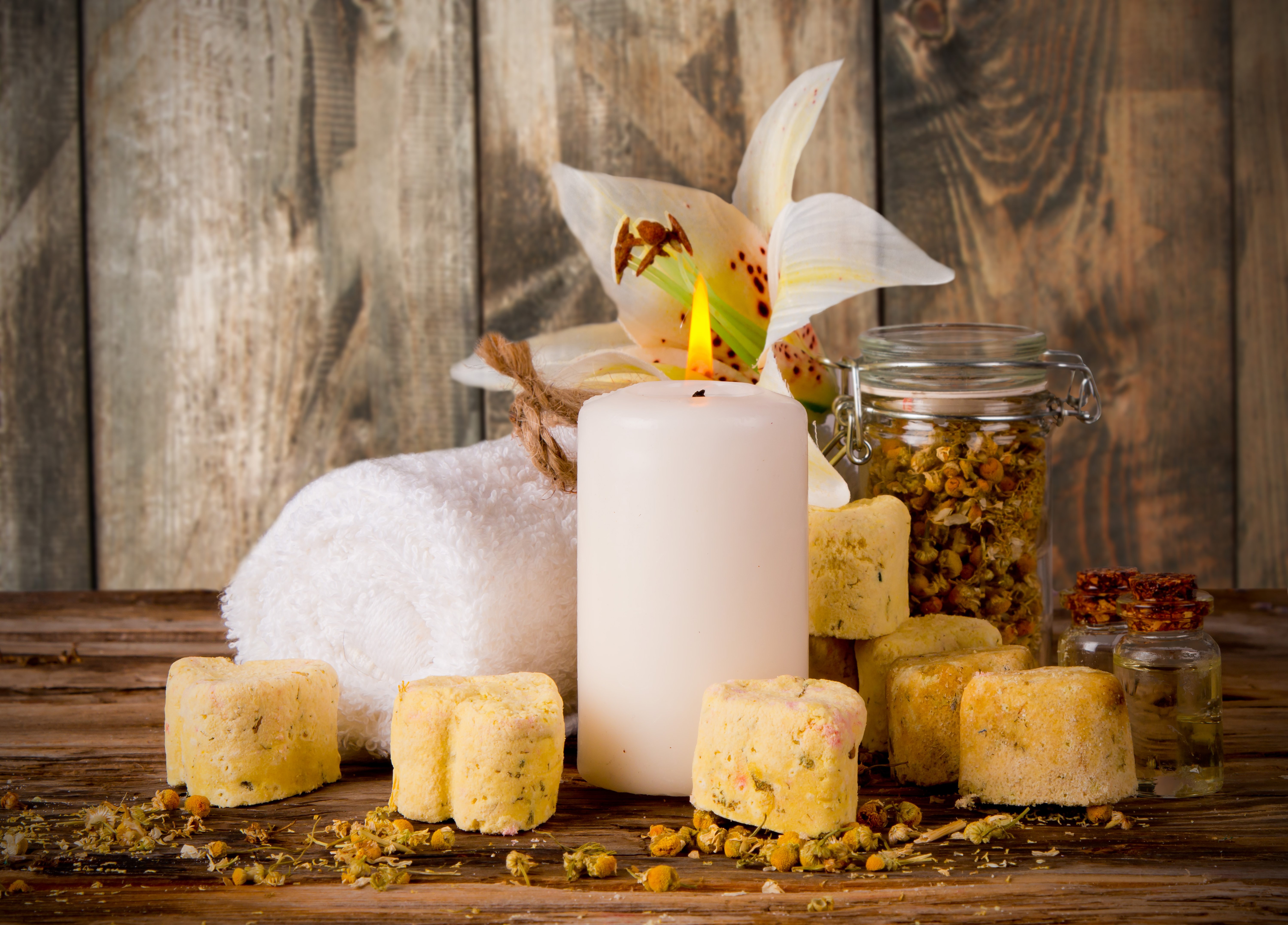 Spa items with candle, towel, and flower HD Wallpaper