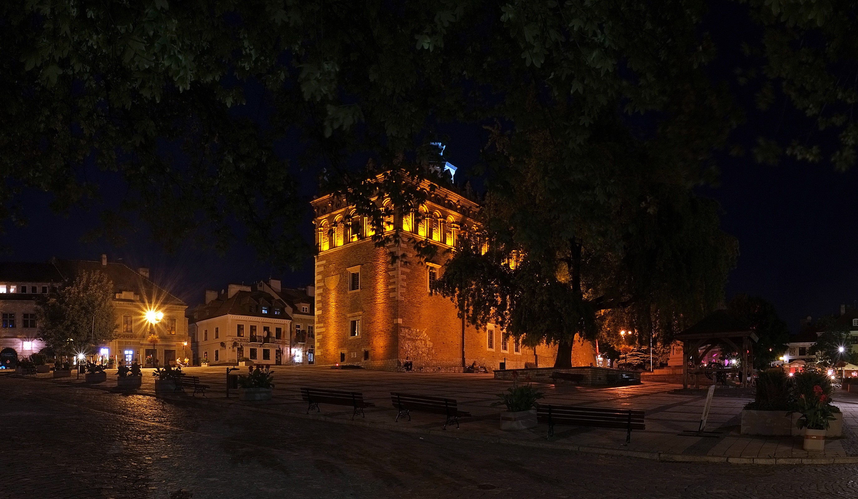 Old town square at night with illuminated building HD Wallpaper