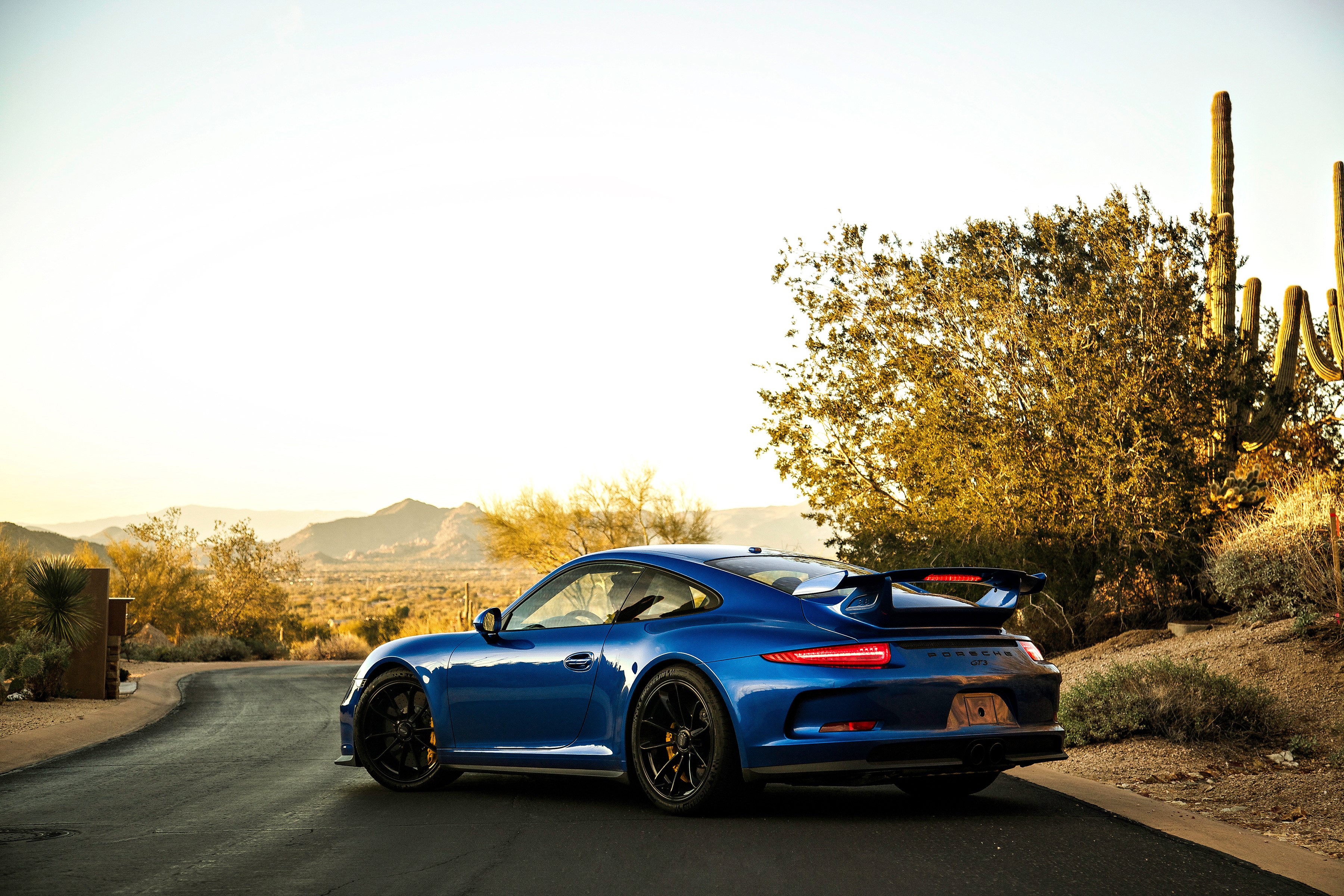 Blue Porsche 911 GT3 in a desert landscape HD Wallpaper