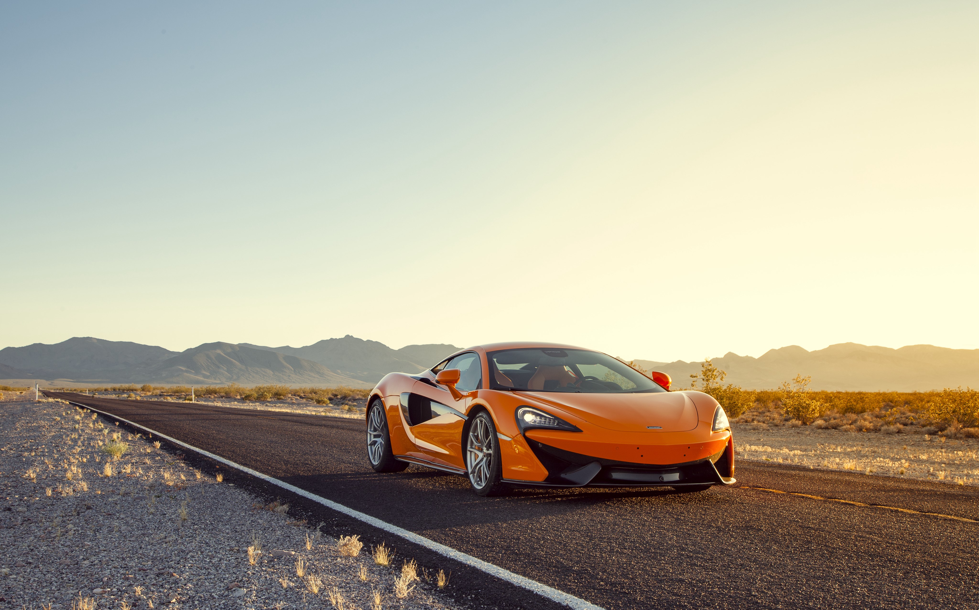 Orange McLaren 570S Coupe on a Desert Road HD Wallpaper
