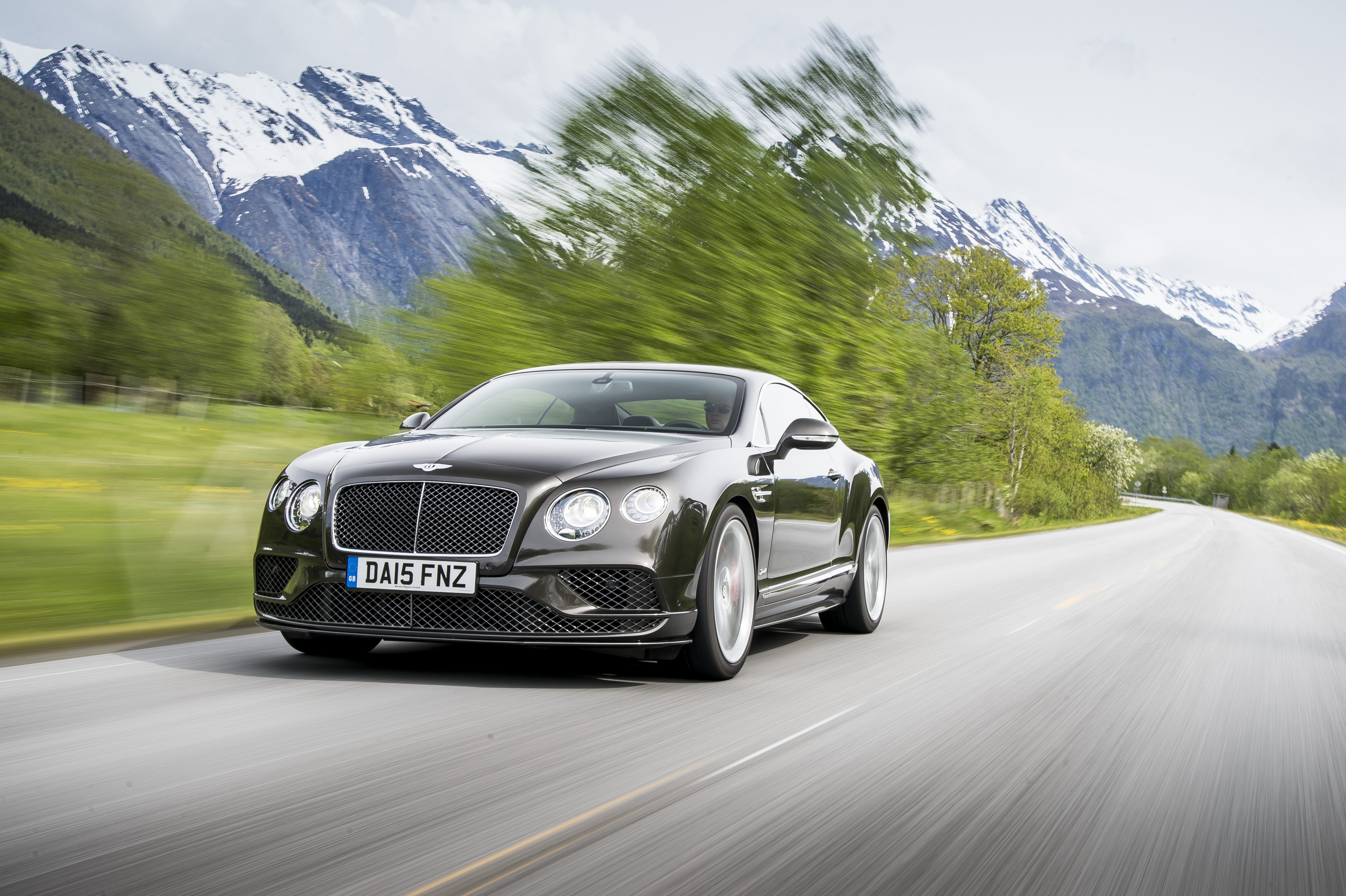 Bentley Continental GT driving on a mountain road HD Wallpaper