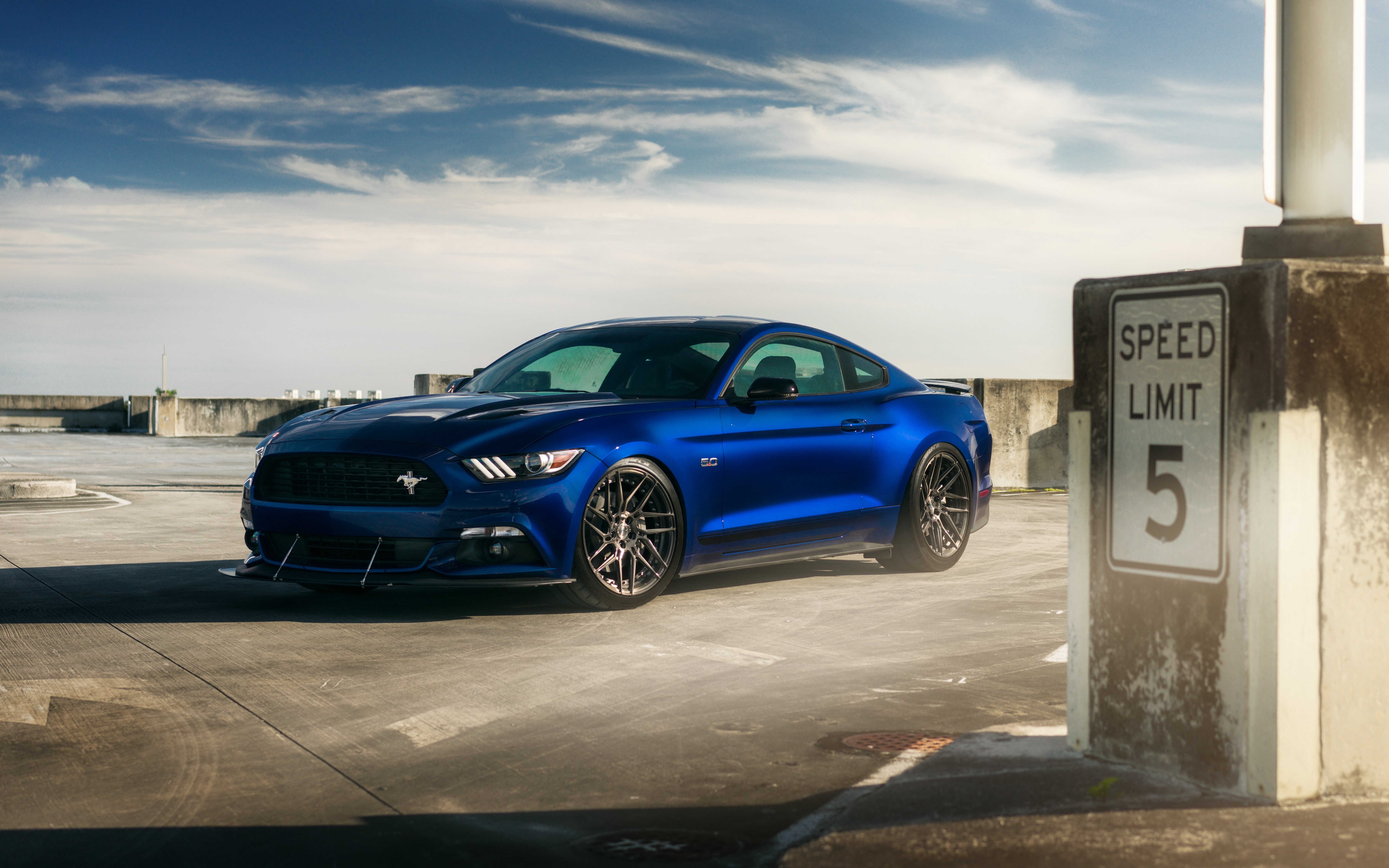 Blue Ford Mustang GT on a rooftop parking lot HD Wallpaper