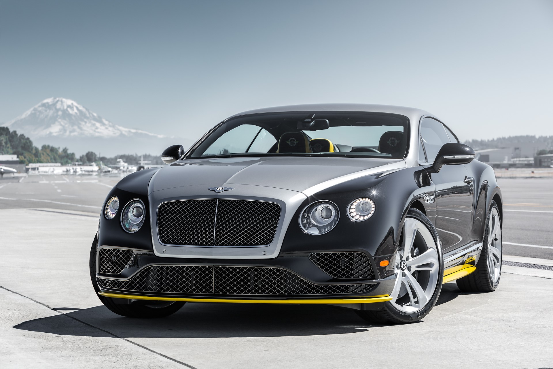 Bentley Continental GT on an airport tarmac with mountains HD Wallpaper