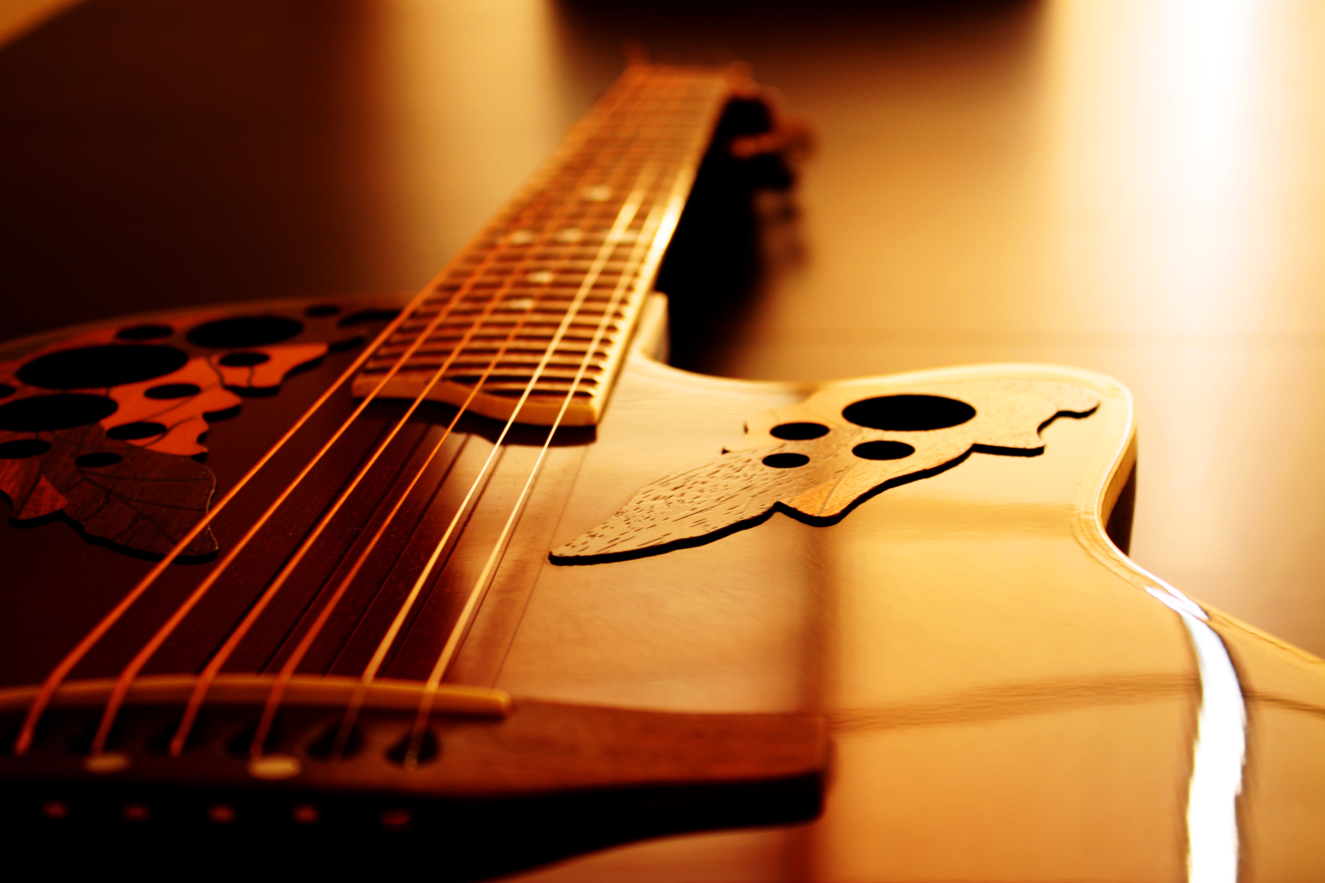 Closeup of an acoustic guitar HD Wallpaper