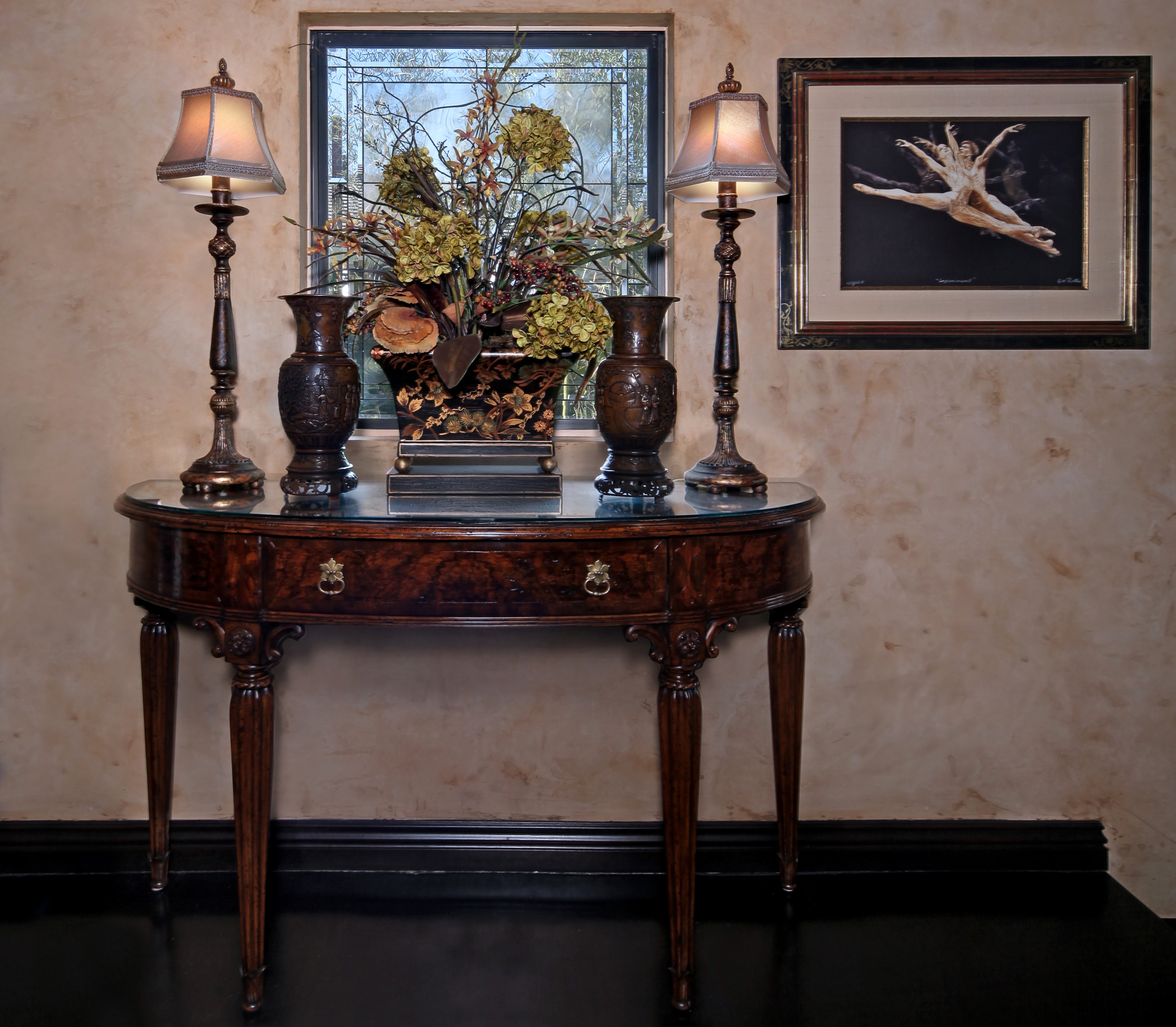 Console table with lamps, vases, and artwork HD Wallpaper
