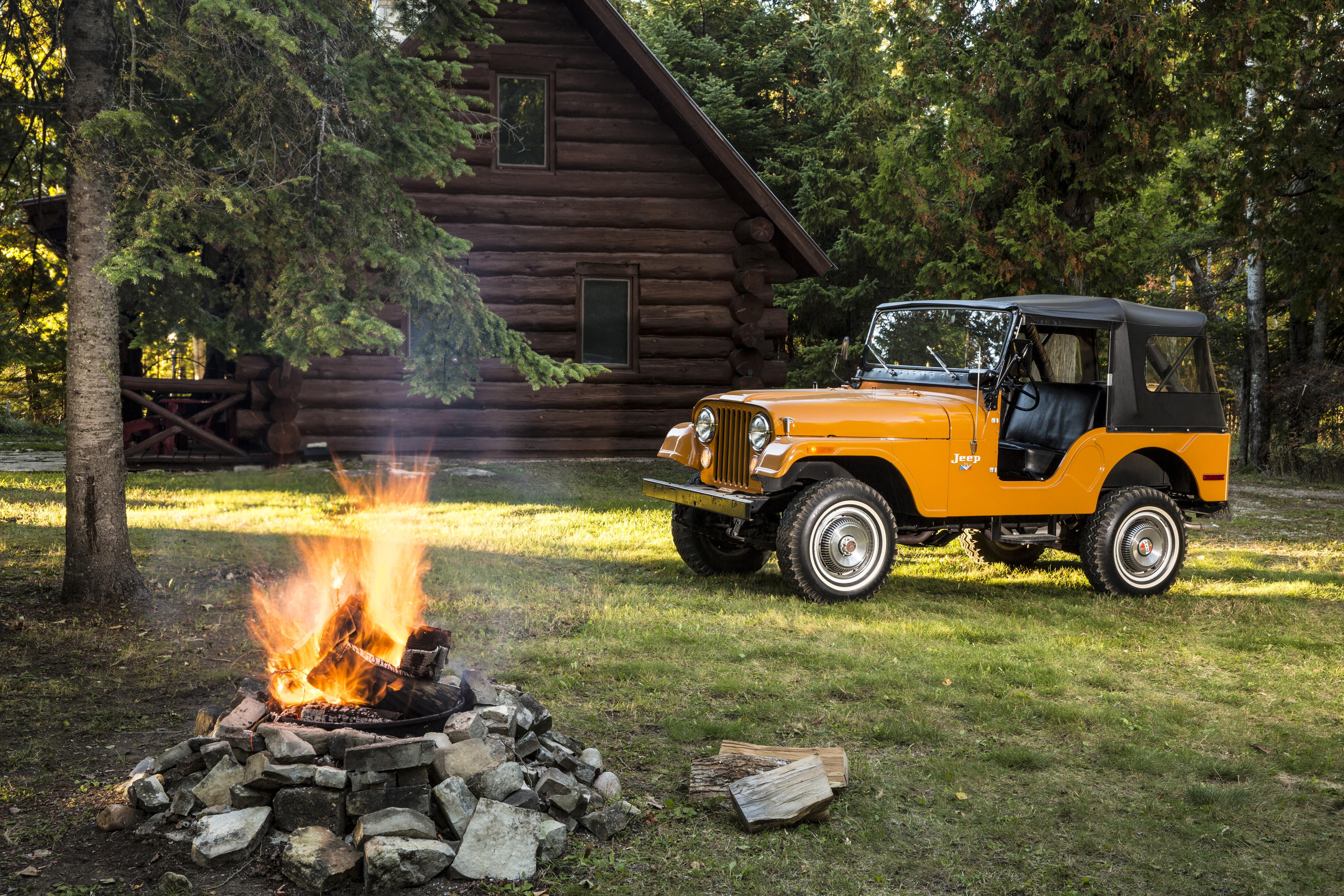 Orange Jeep CJ-5 by Log Cabin with Campfire HD Wallpaper