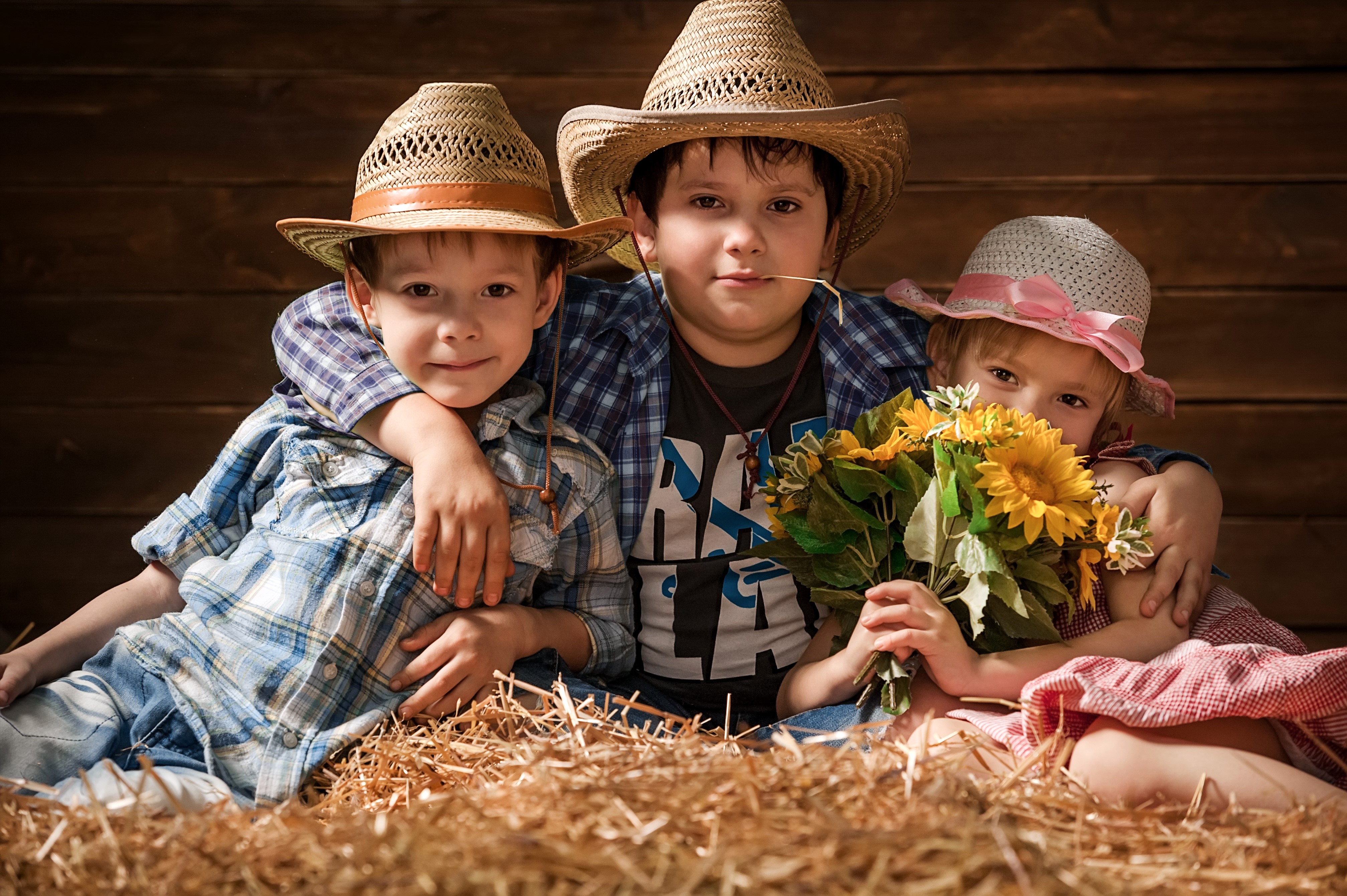 Three children in cowboy hats with sunflowers HD Wallpaper