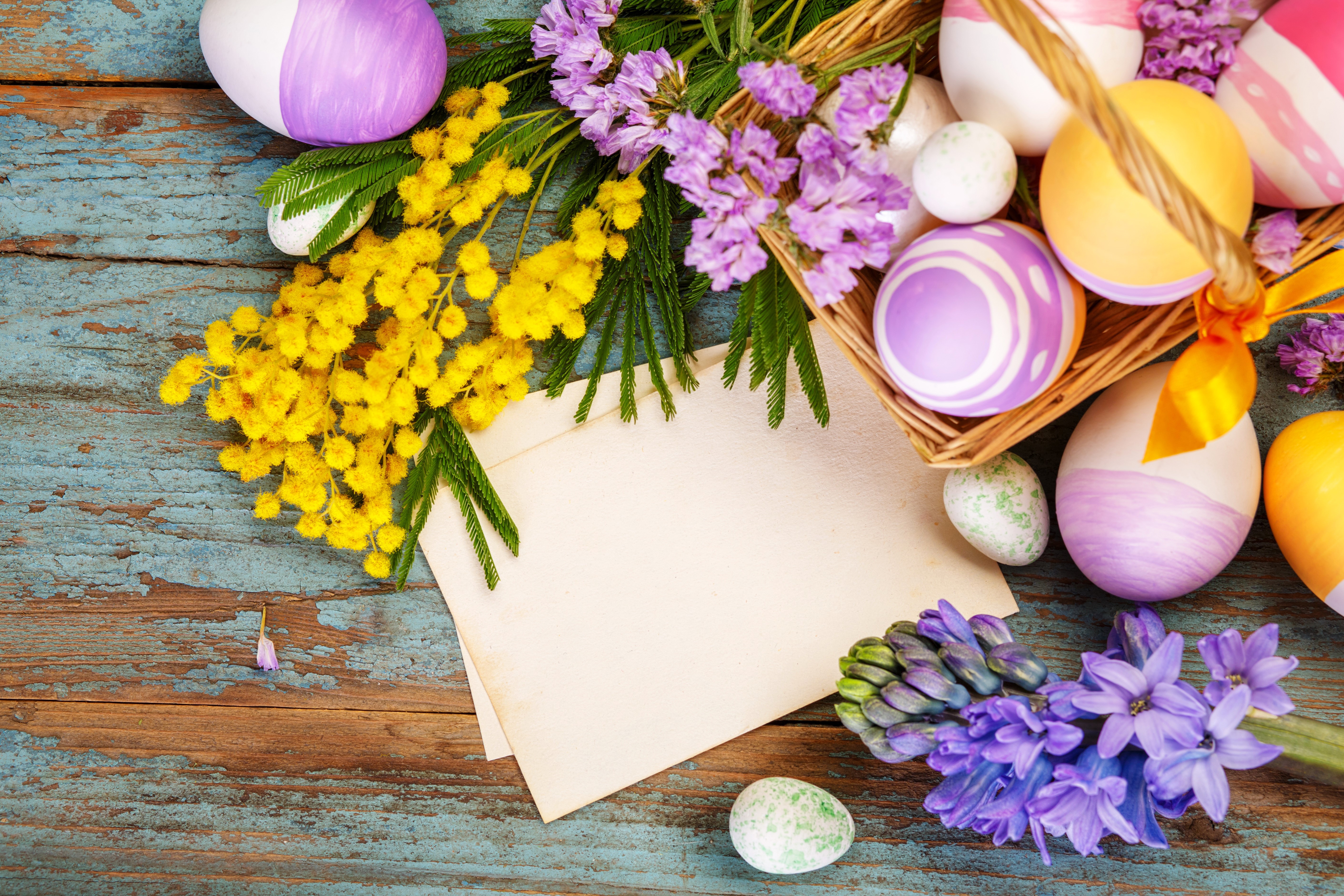 Easter eggs with mimosa and hyacinths on a wooden table HD Wallpaper