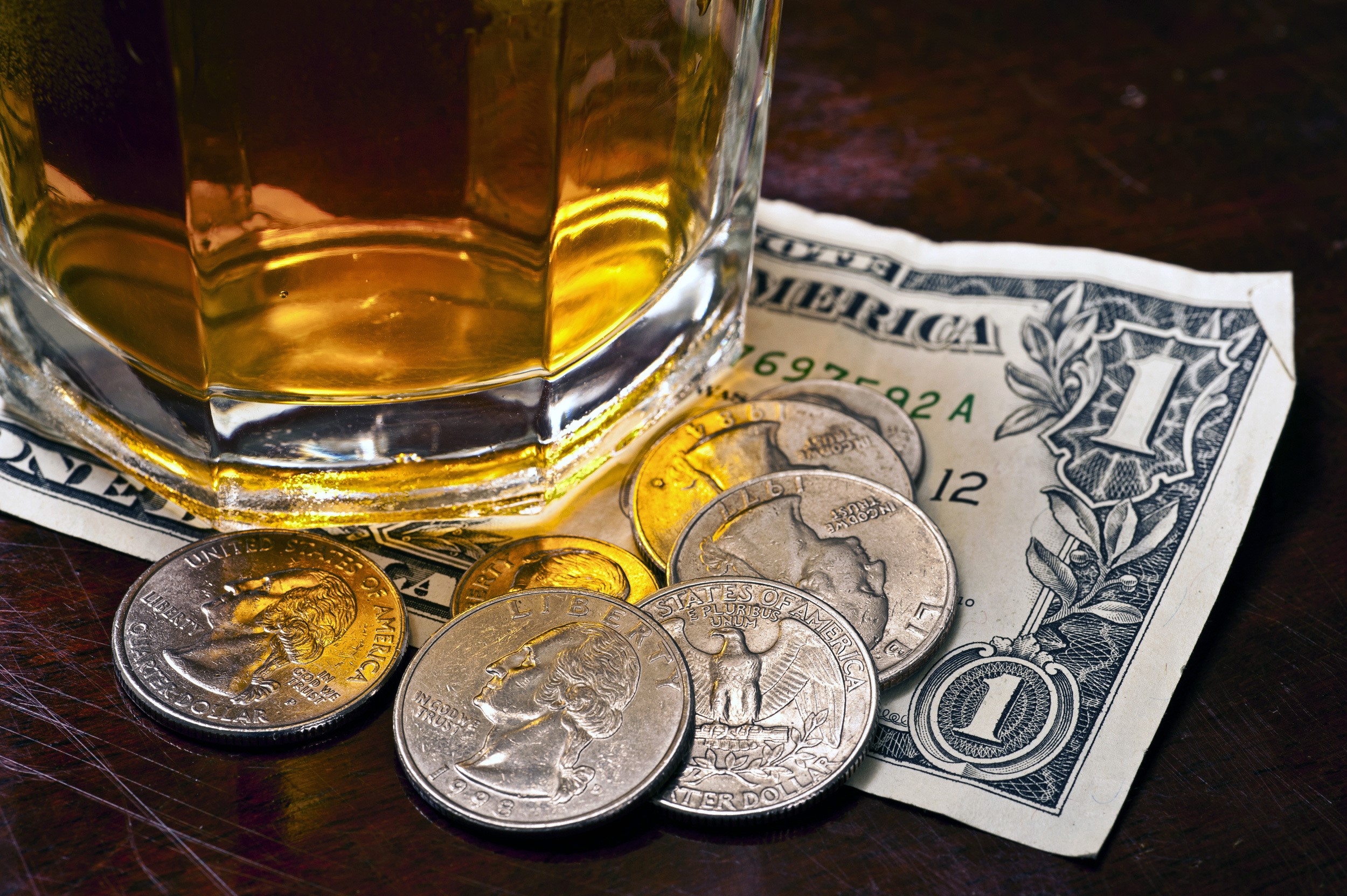 Whiskey glass with dollar bill and coins HD Wallpaper