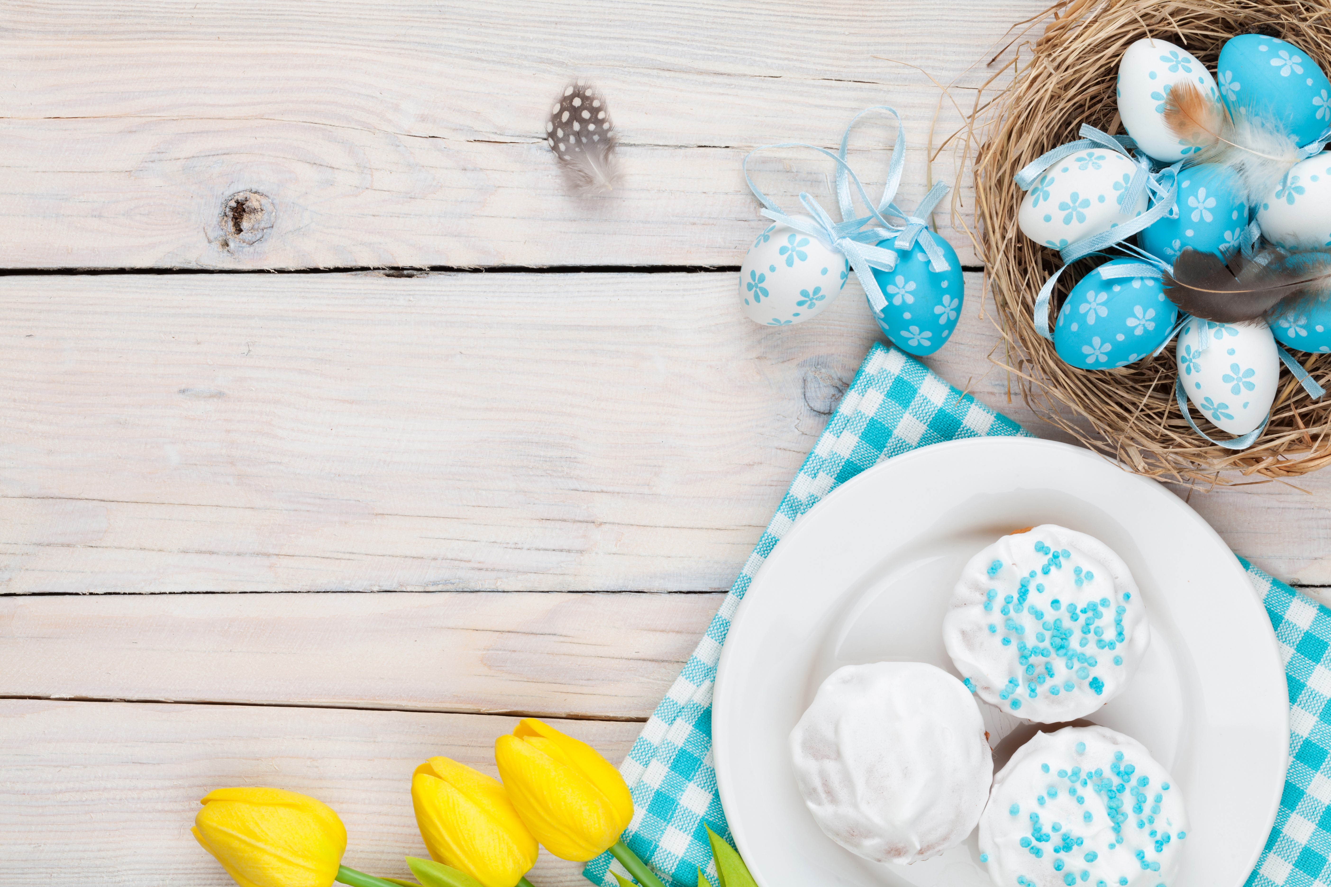 Easter eggs in a nest with tulips and pastries HD Wallpaper