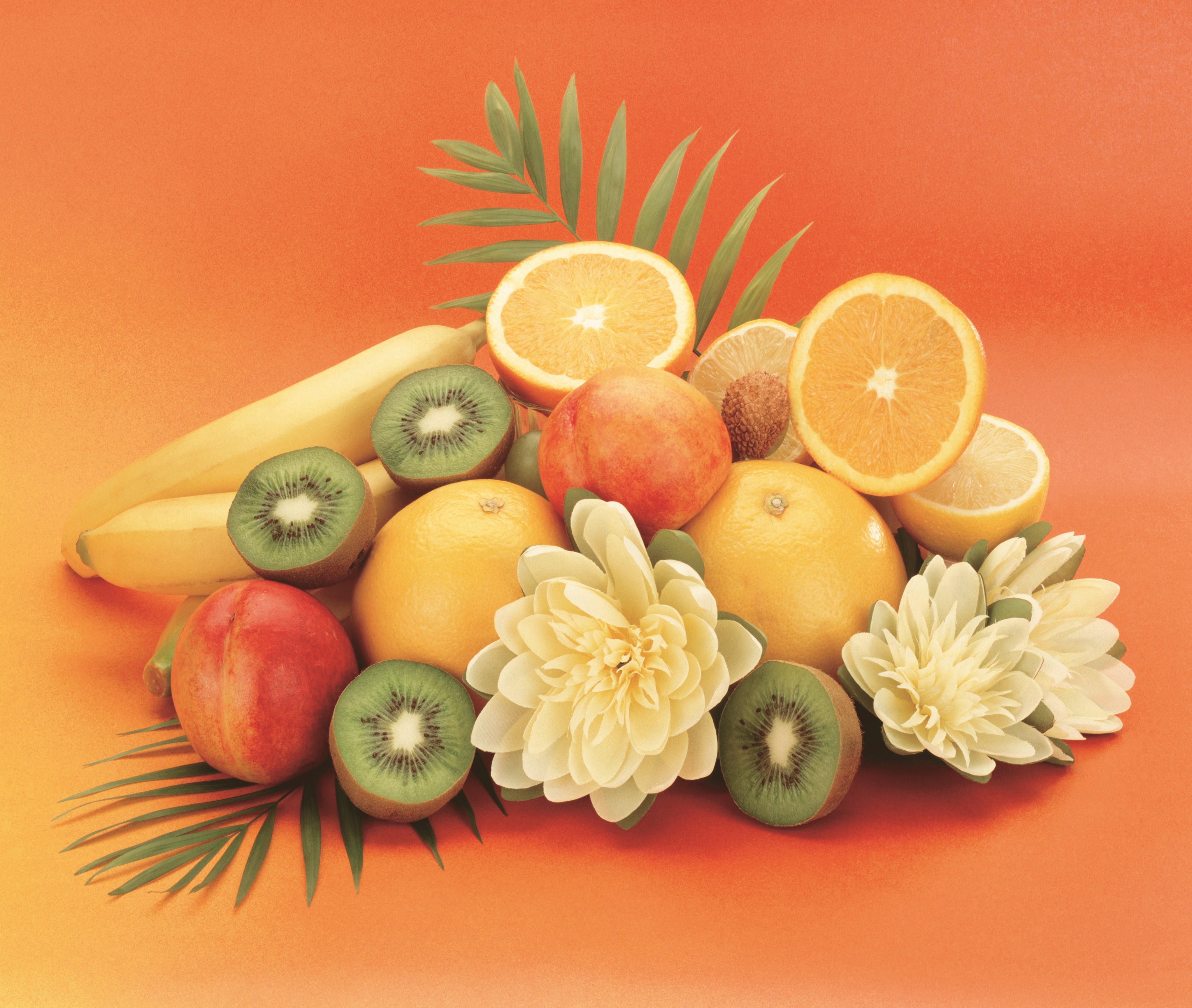 Fruit arrangement with oranges, kiwis, bananas, peaches, and flowers HD Wallpaper