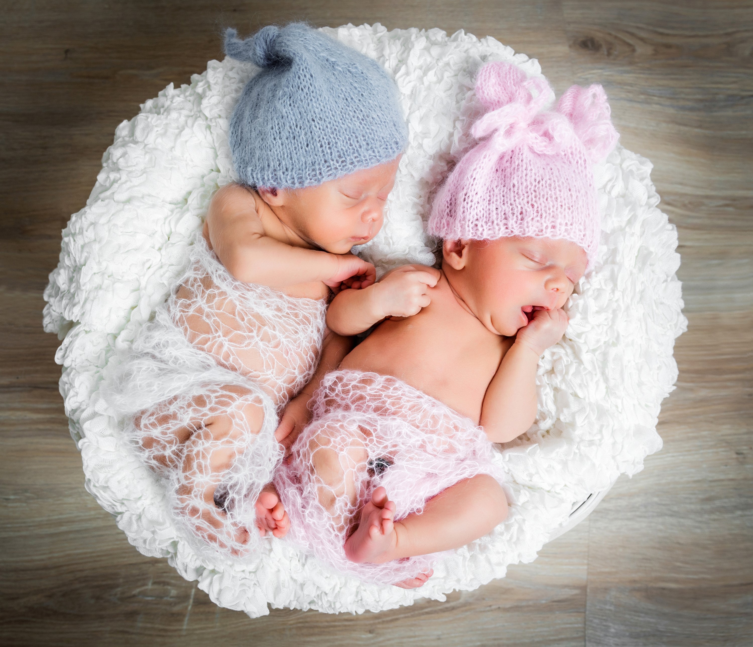 Two Newborn Twins Sleeping in a Basket HD Wallpaper