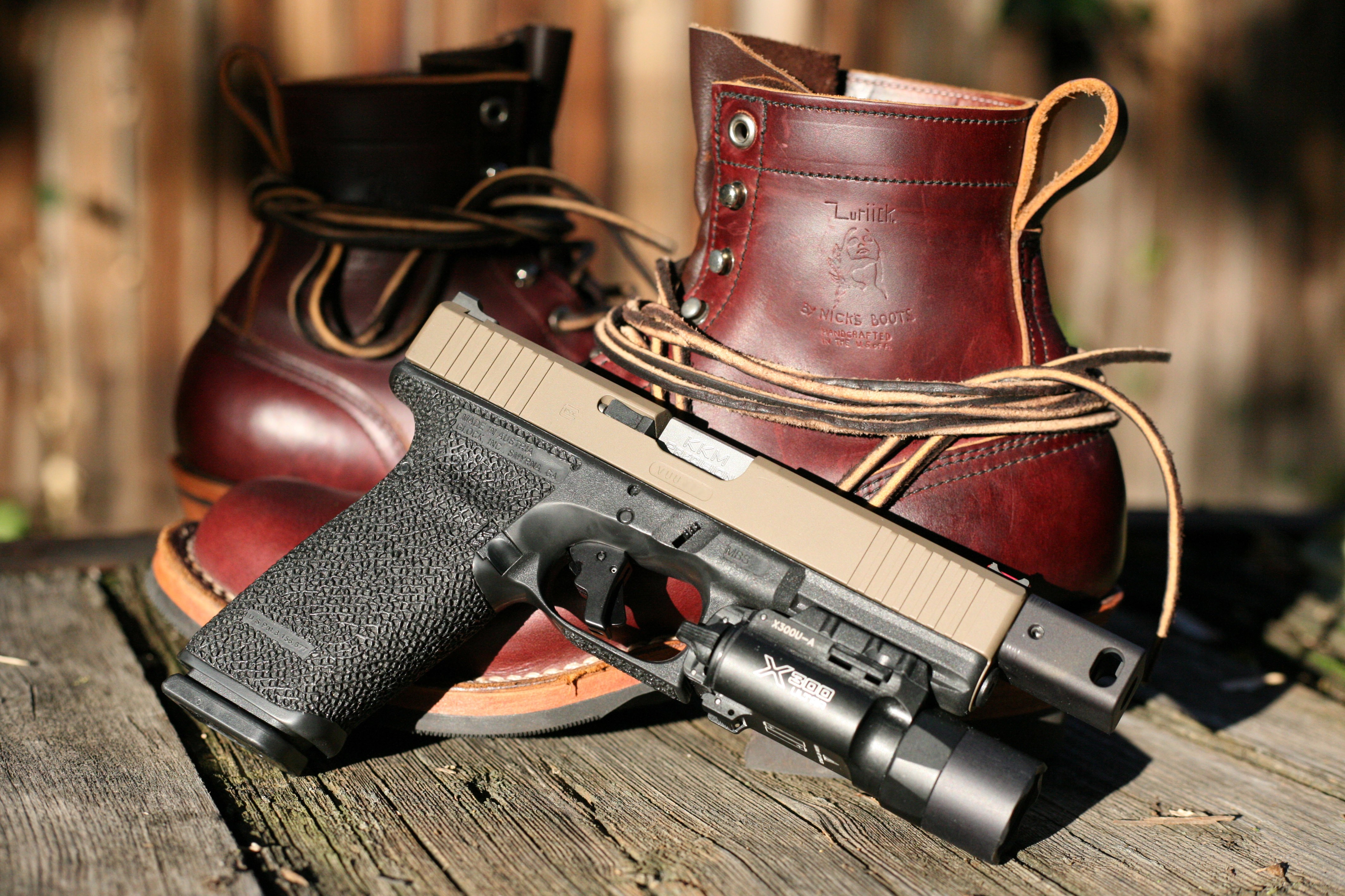 4K Glock pistol with boots HD Wallpaper