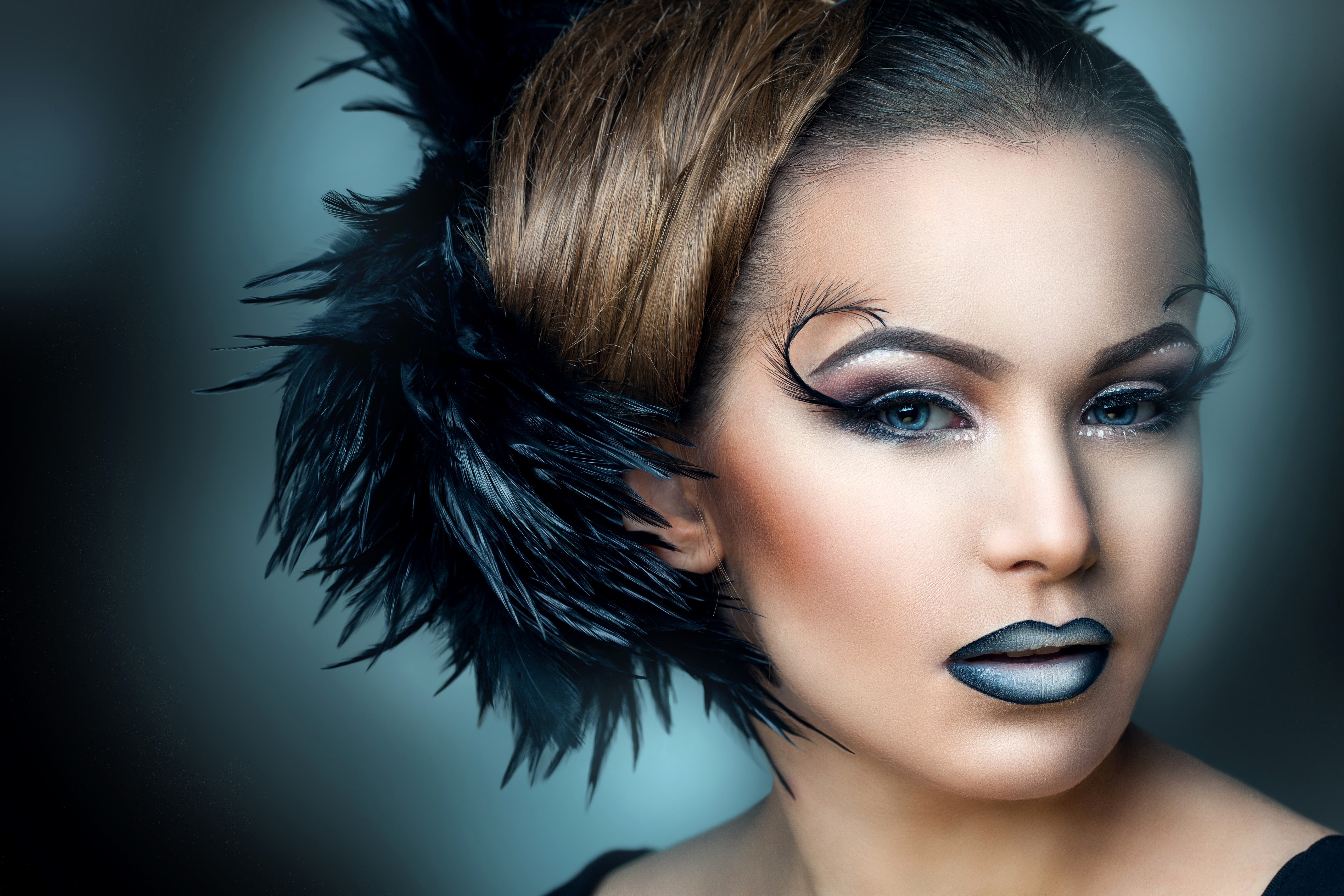 Woman with dramatic makeup and black feathers HD Wallpaper