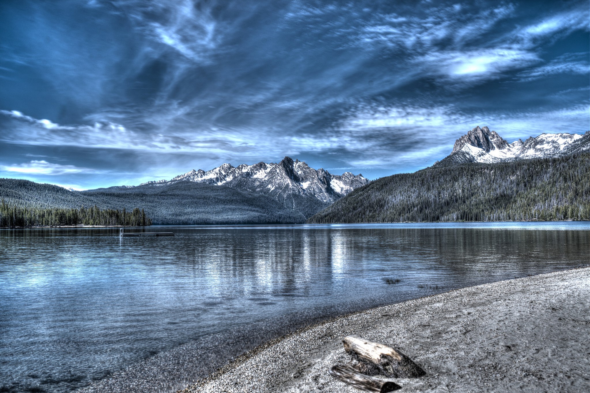 Lake and snow-capped mountains under a cloudy sky HD Wallpaper