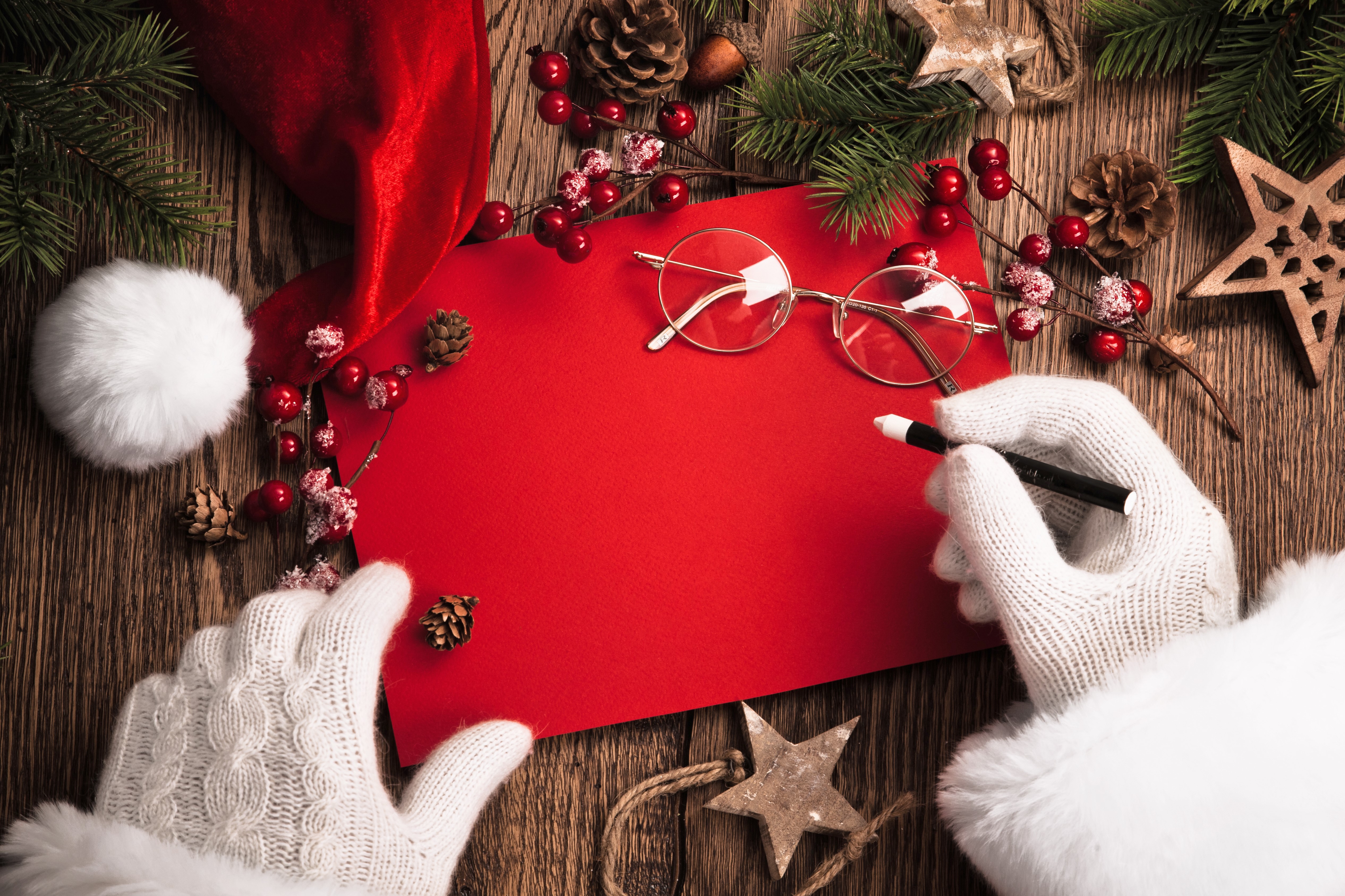Santa writing a Christmas list with glasses HD Wallpaper
