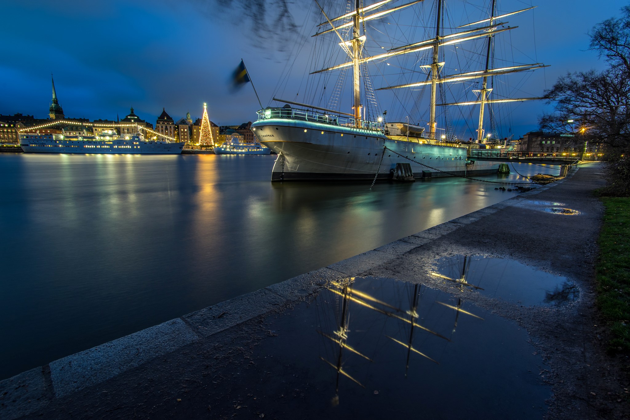 Tall ship docked in Stockholm harbor at night HD Wallpaper