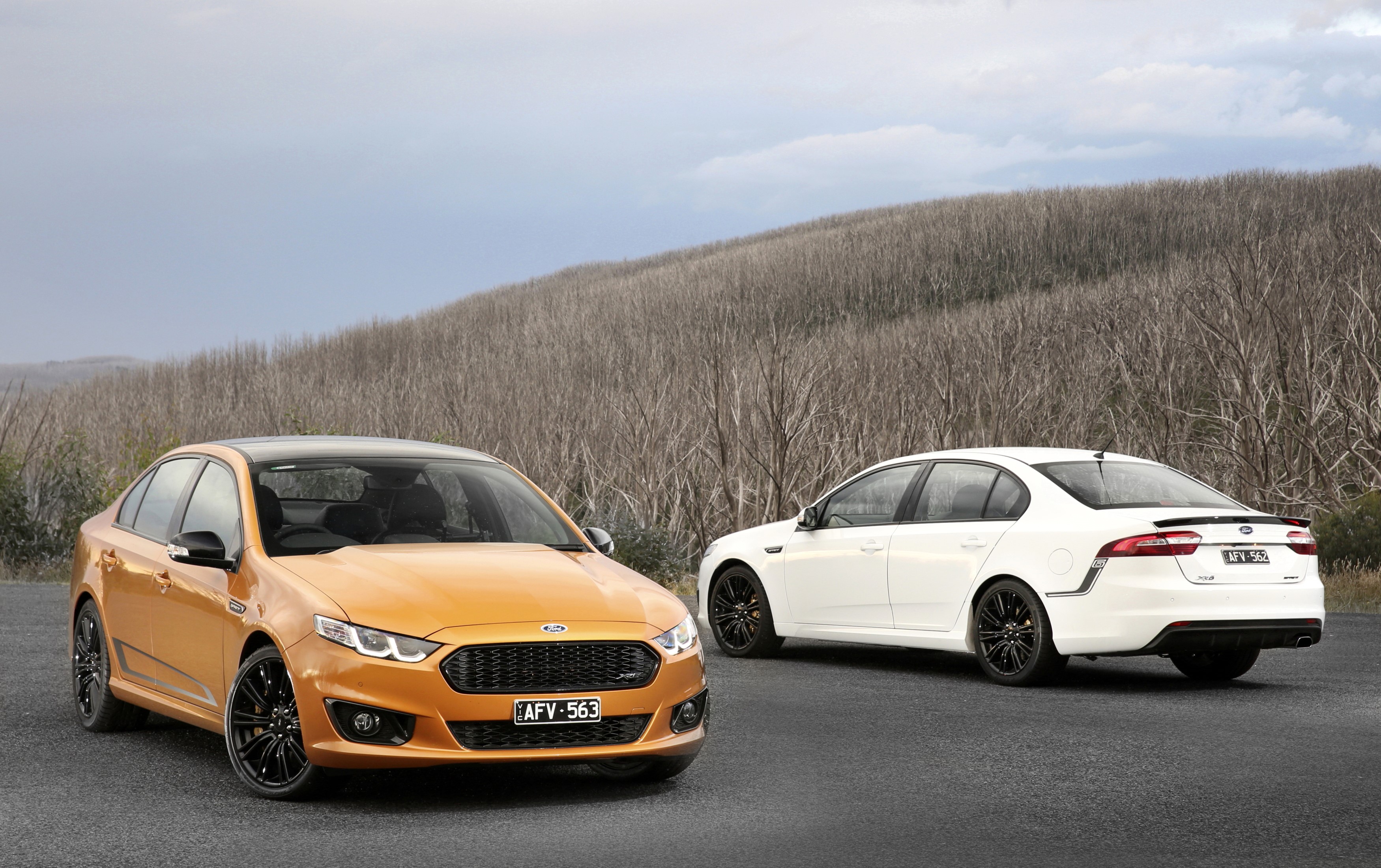 Two Ford Falcon sedans, orange and white, outdoors HD Wallpaper