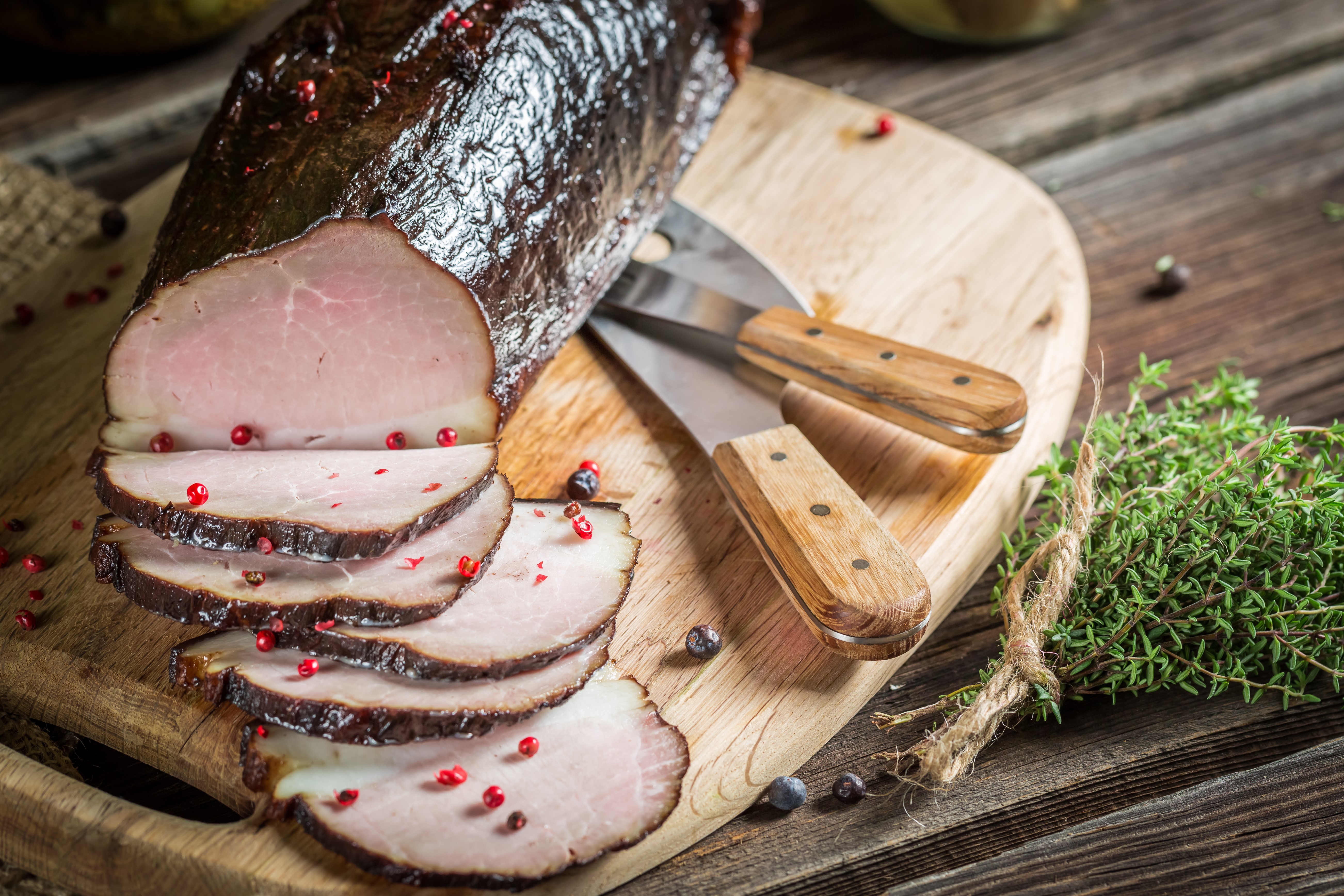 Smoked ham with peppercorns on a cutting board HD Wallpaper