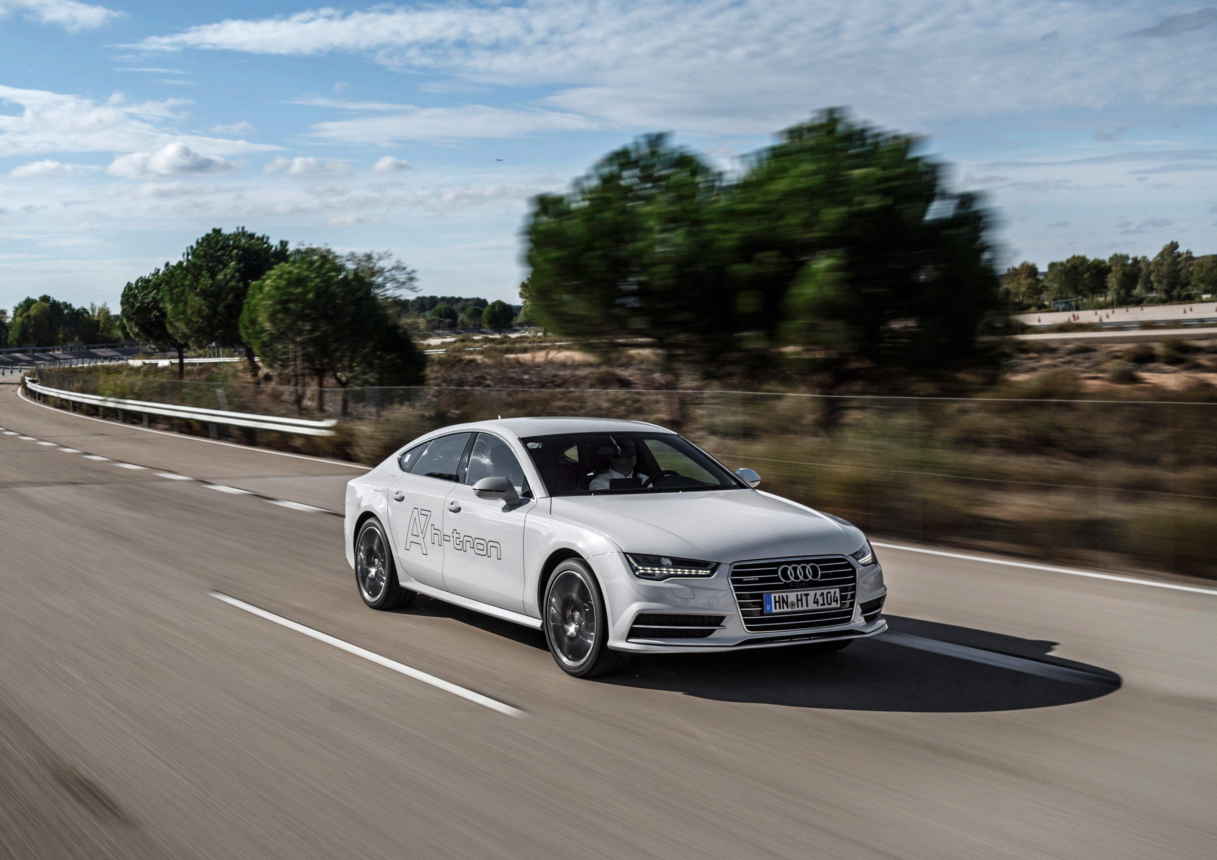 Audi A7 h-tron quattro driving on a road HD Wallpaper