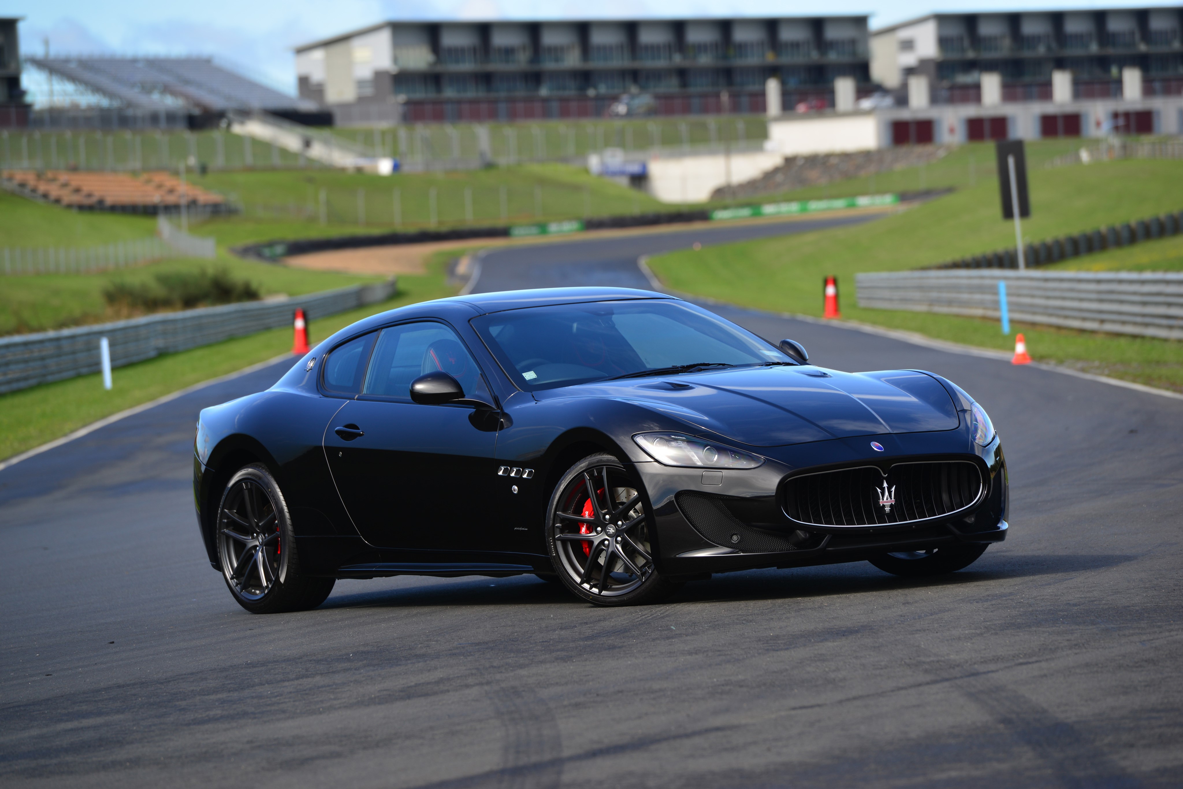 Black 2015 Maserati GranTurismo MC Sportline on a race track HD Wallpaper