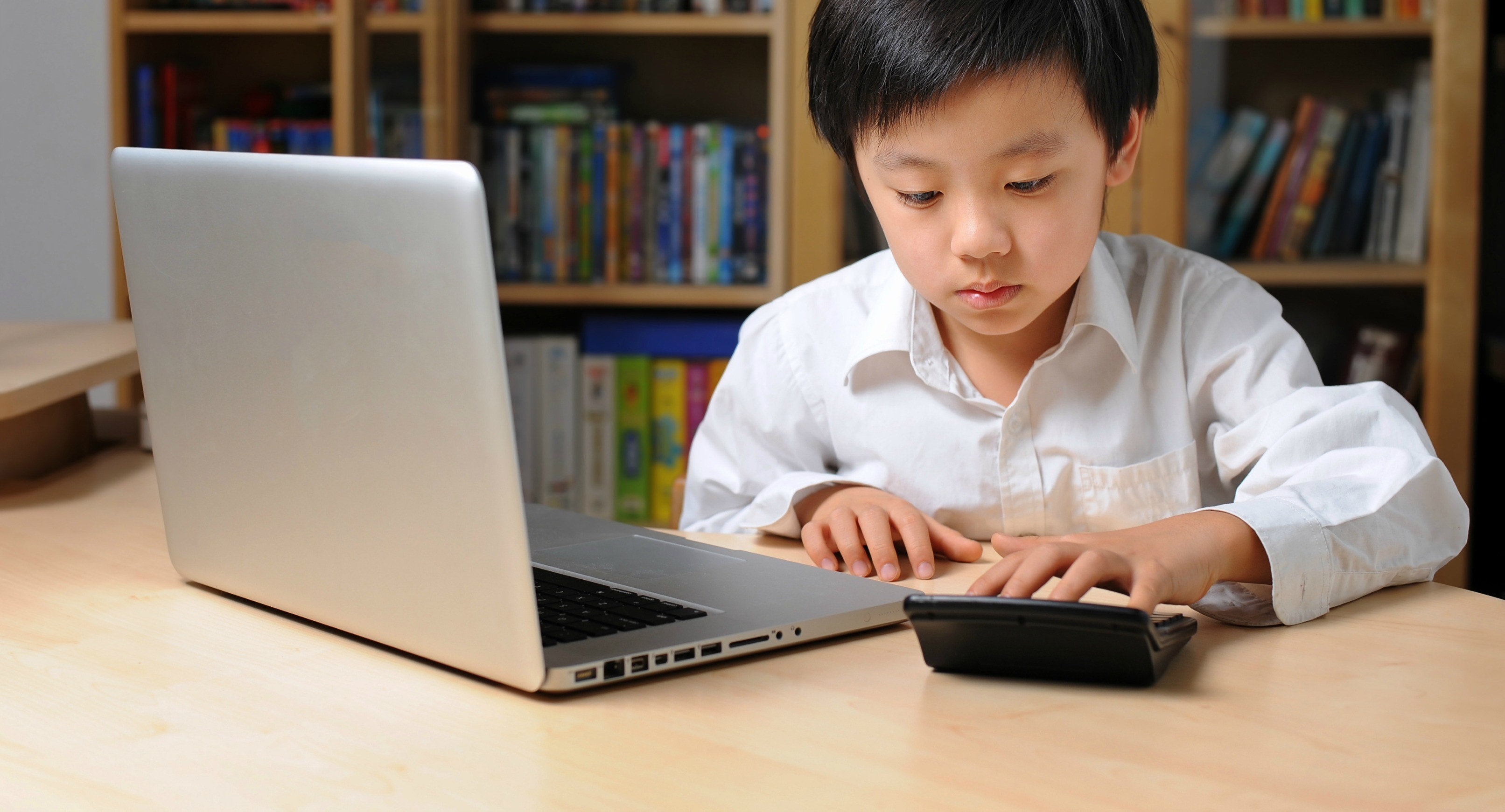 Boy using a laptop and calculator HD Wallpaper