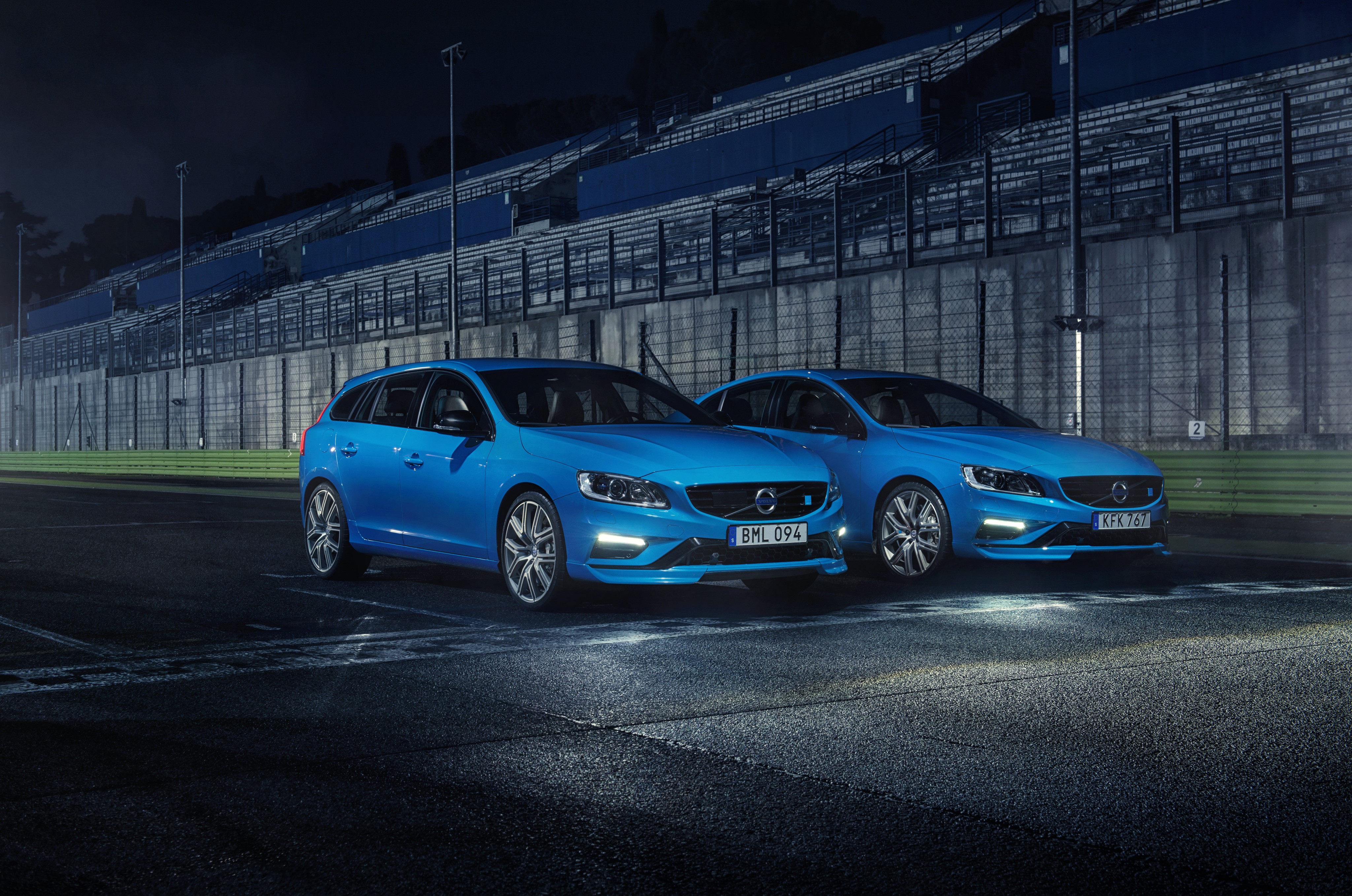 Two blue Volvo V60 wagons on a race track HD Wallpaper