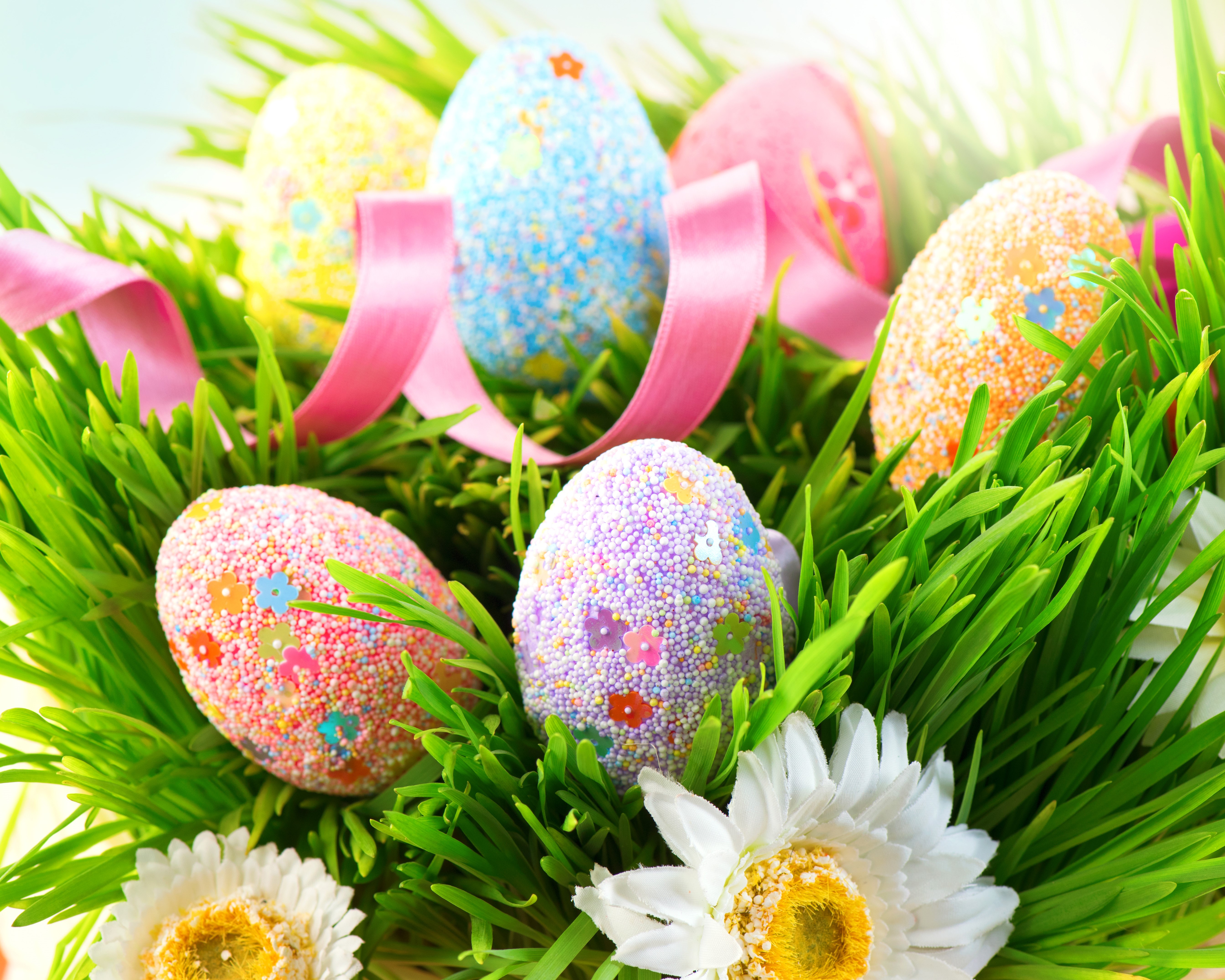 Easter eggs decorated with sprinkles and flowers in grass HD Wallpaper