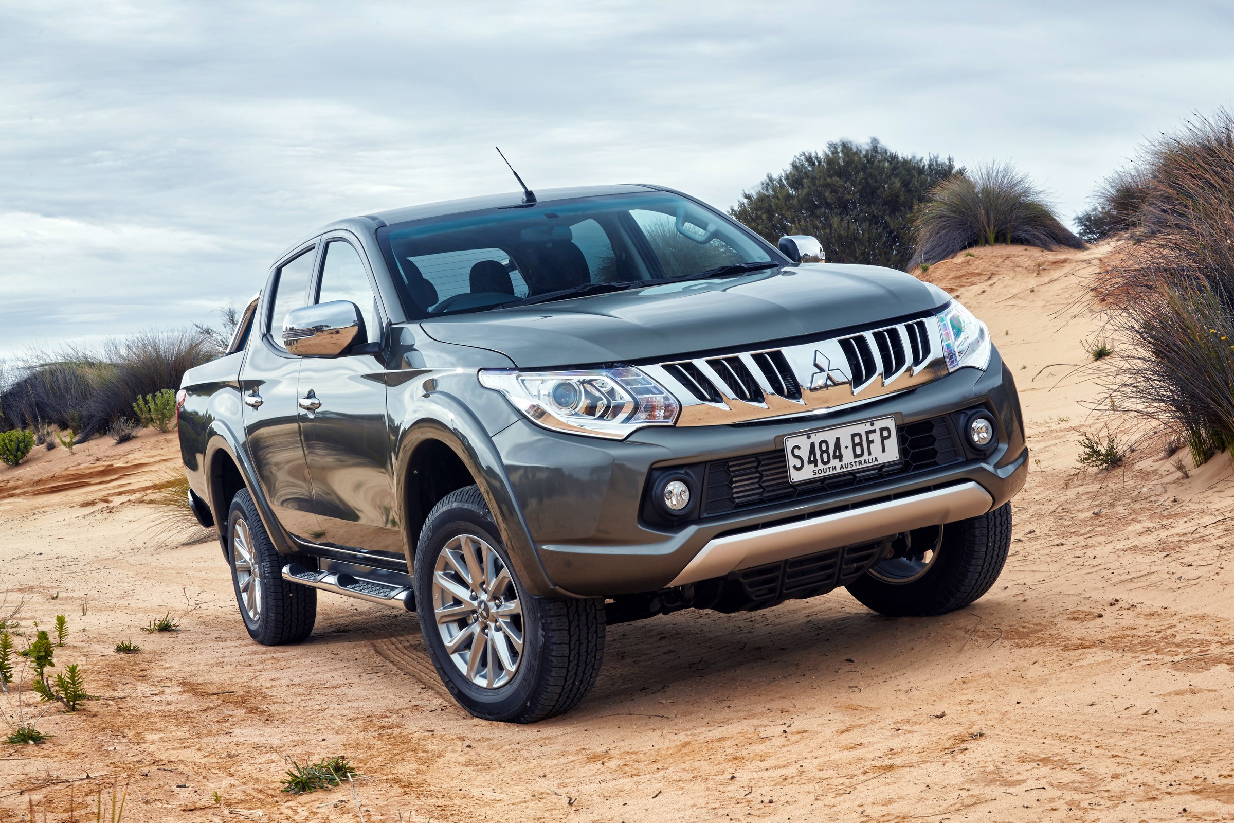 Mitsubishi Triton Double Cab on a sandy terrain HD Wallpaper