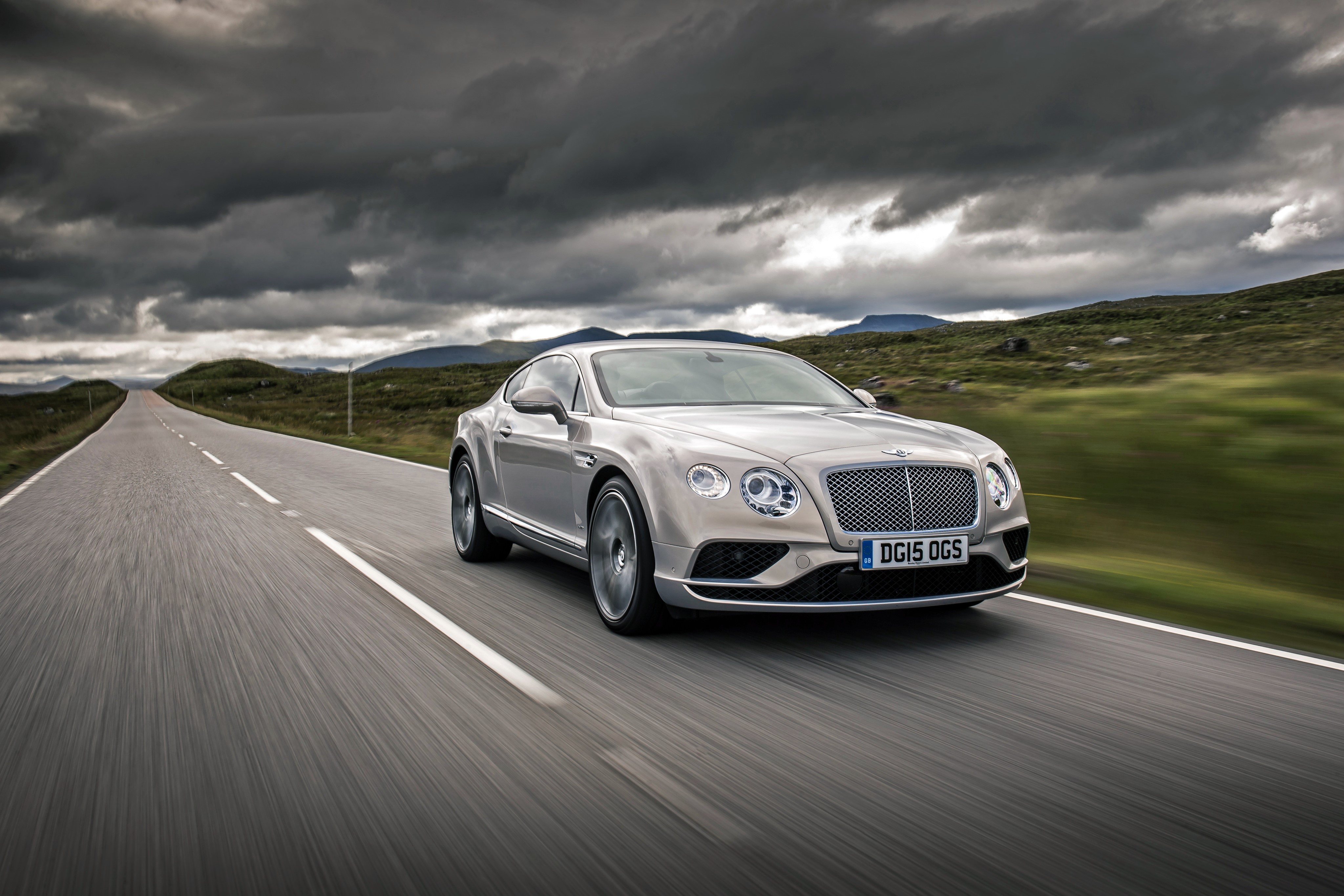 Bentley Continental GT driving on a road HD Wallpaper