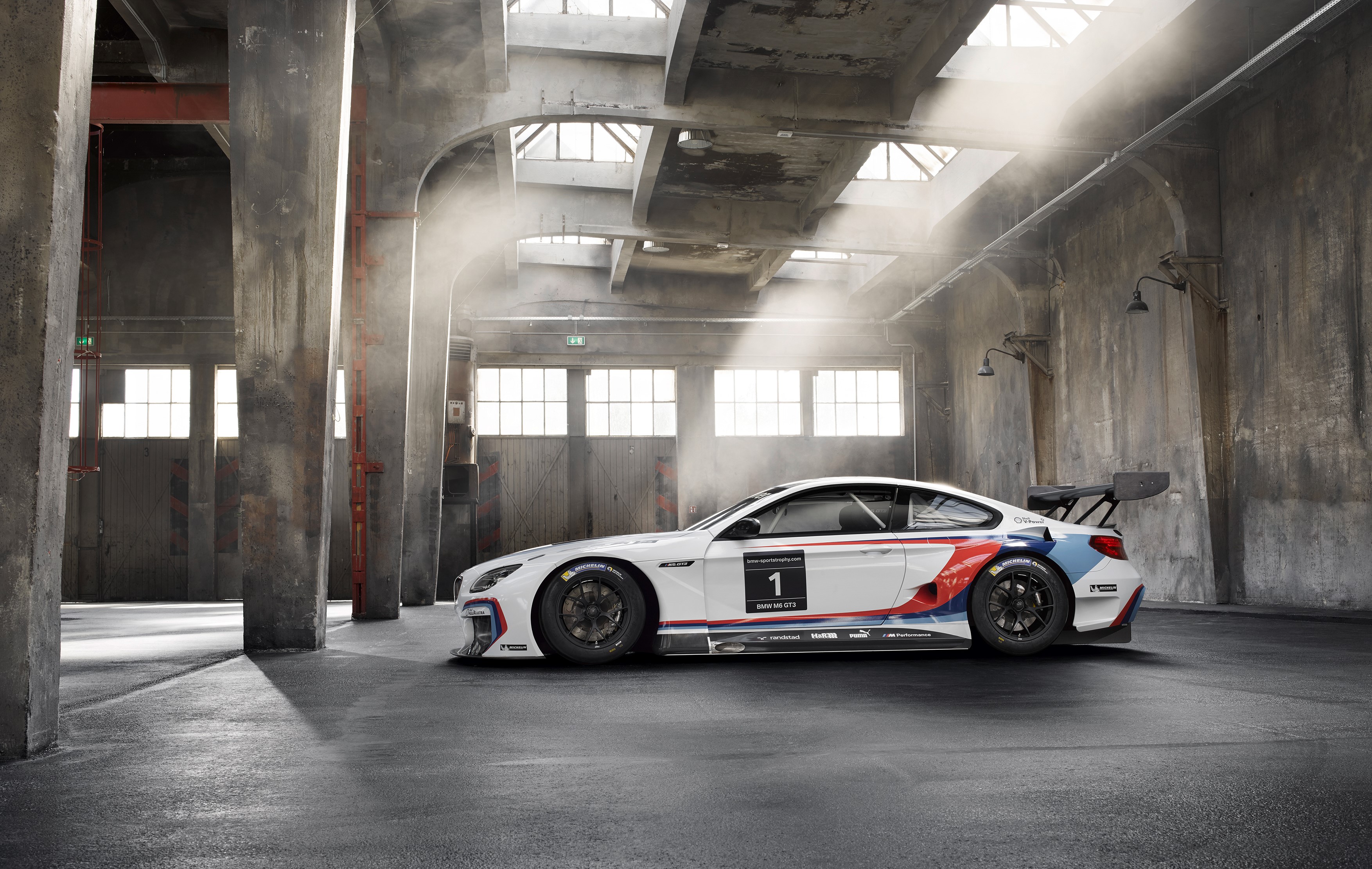 BMW M6 GT3 race car in a warehouse HD Wallpaper