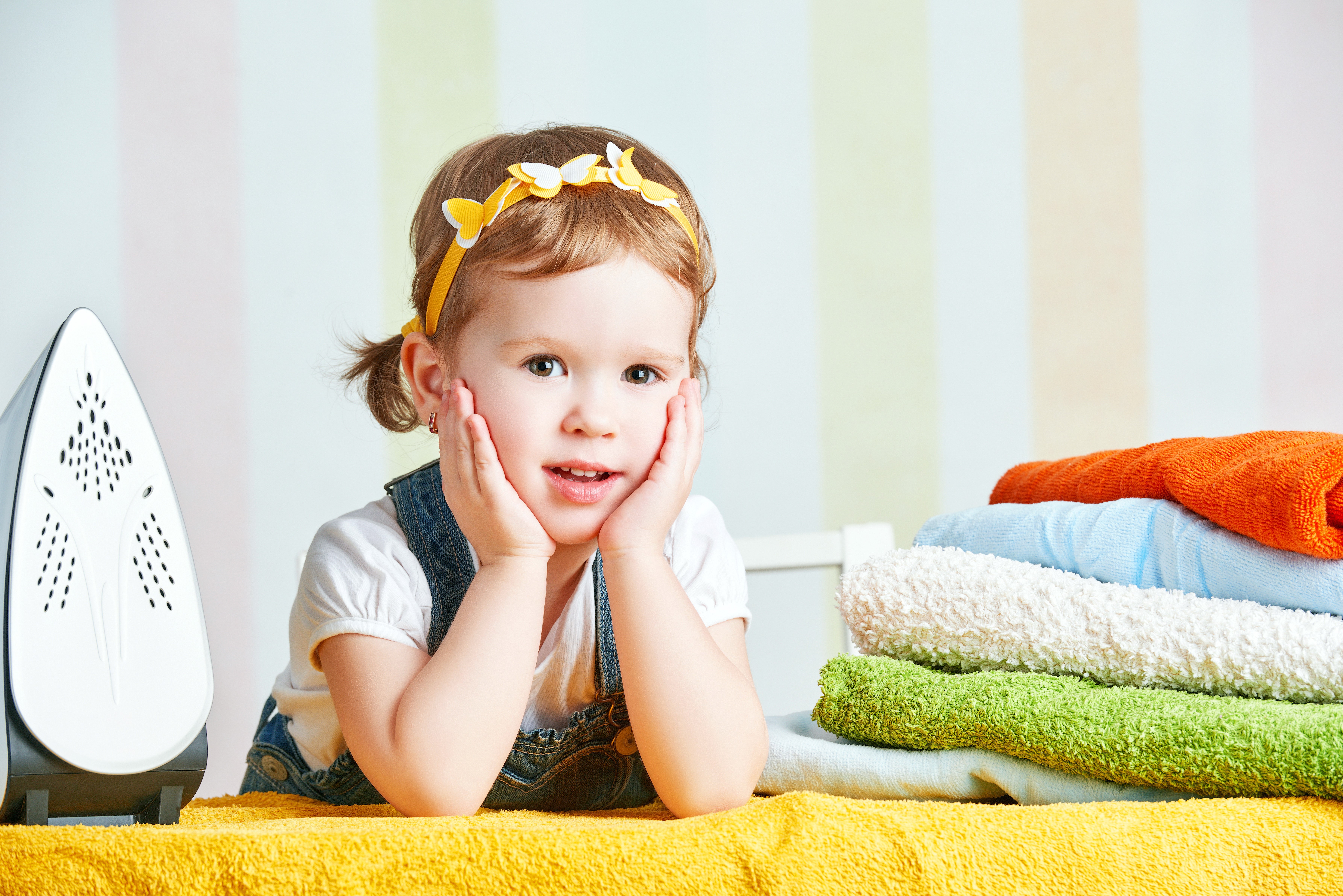 Little girl with ironing board and towels HD Wallpaper