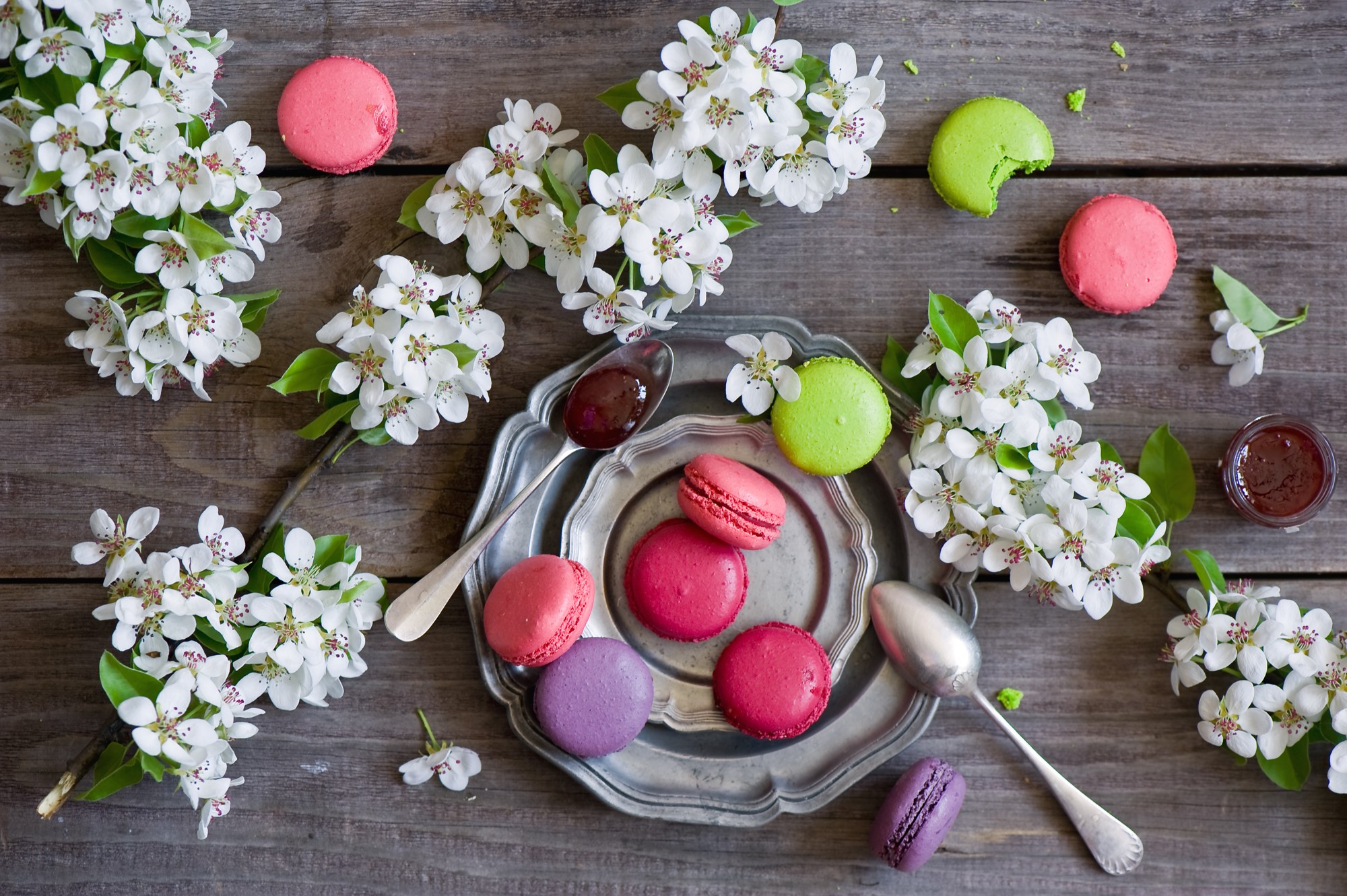 Macarons and pear blossoms on a wooden table HD Wallpaper