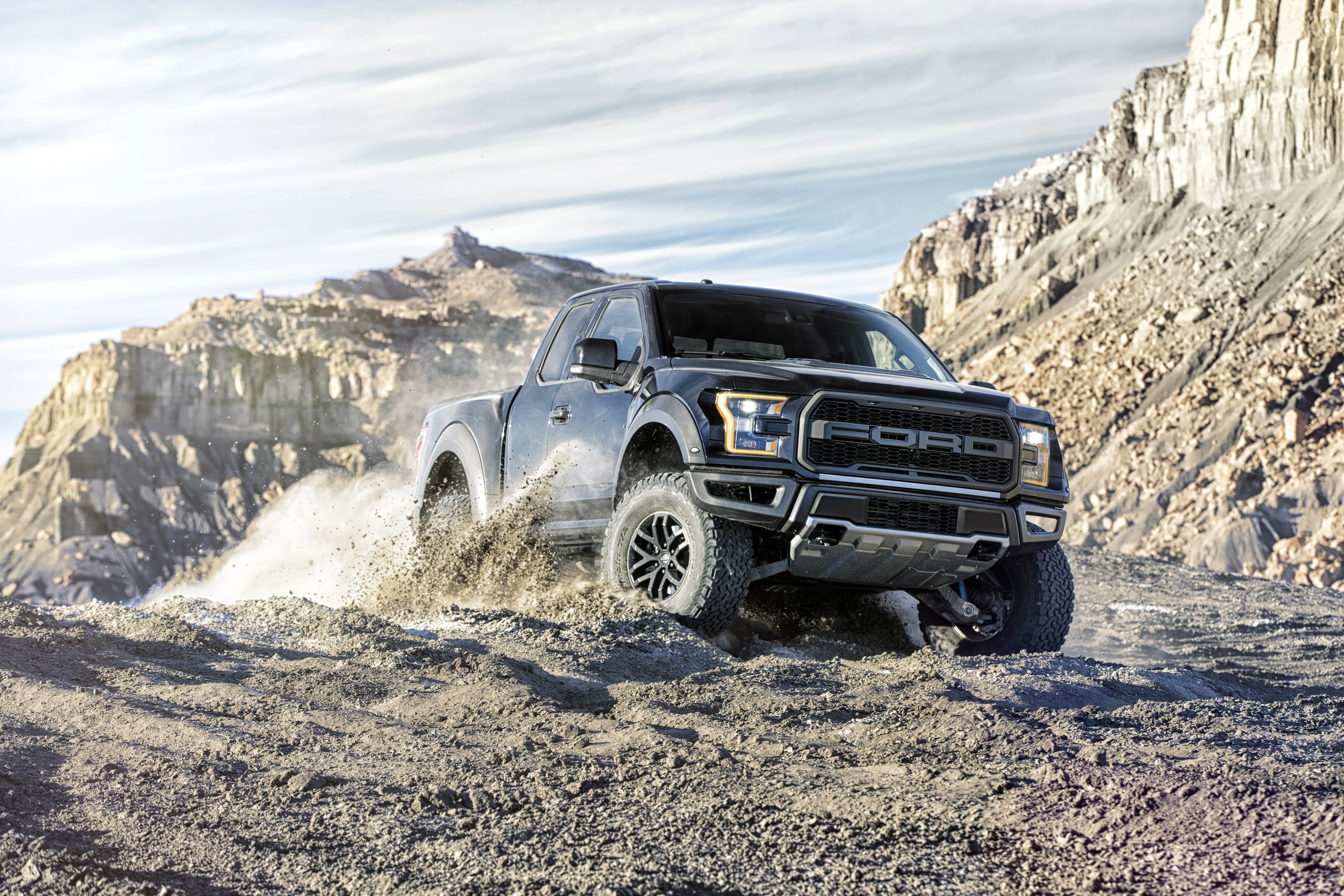 Black Ford F-150 Raptor driving off-road HD Wallpaper