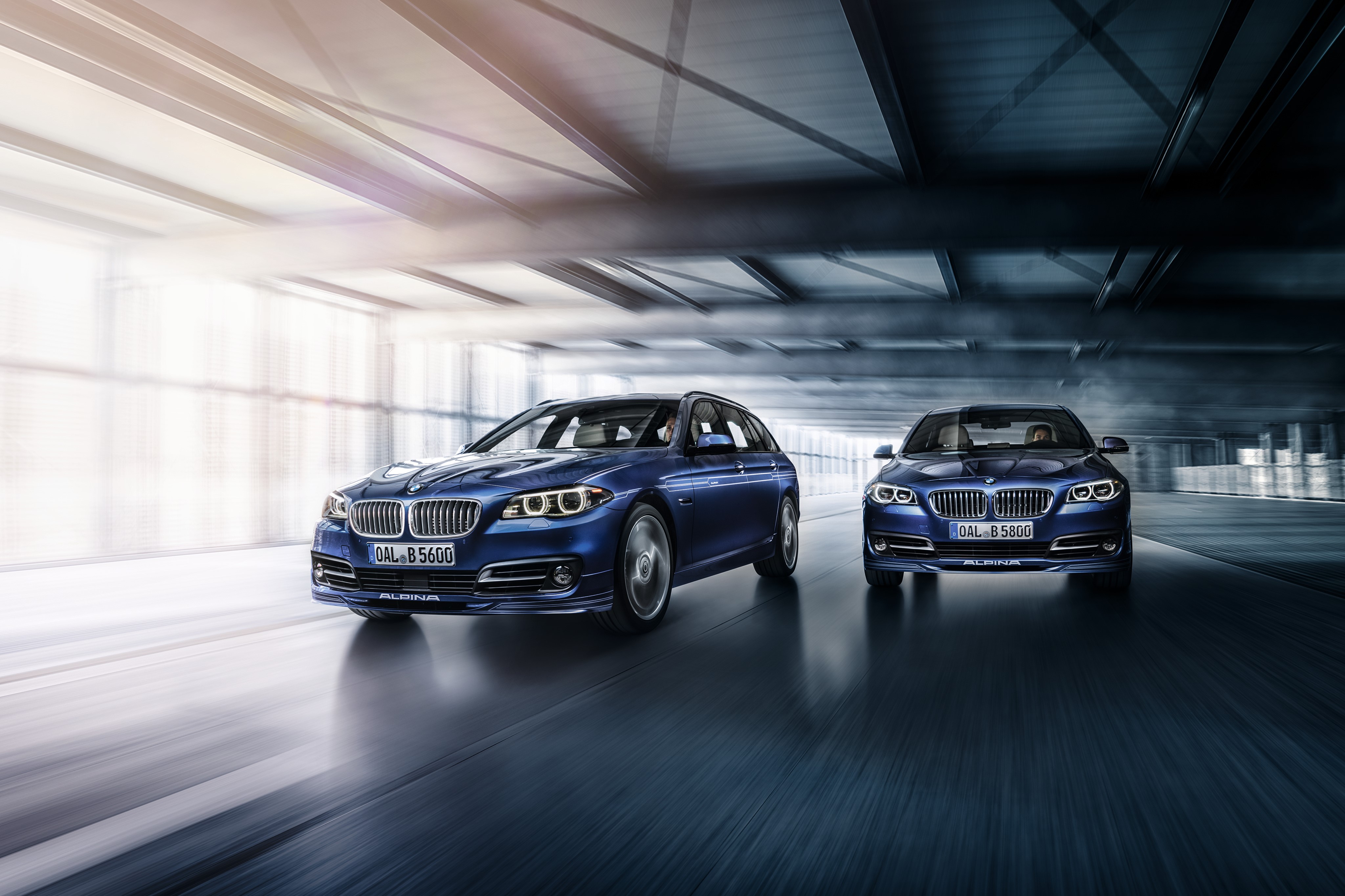 Two blue Alpina 5-Series Sedans on a road HD Wallpaper