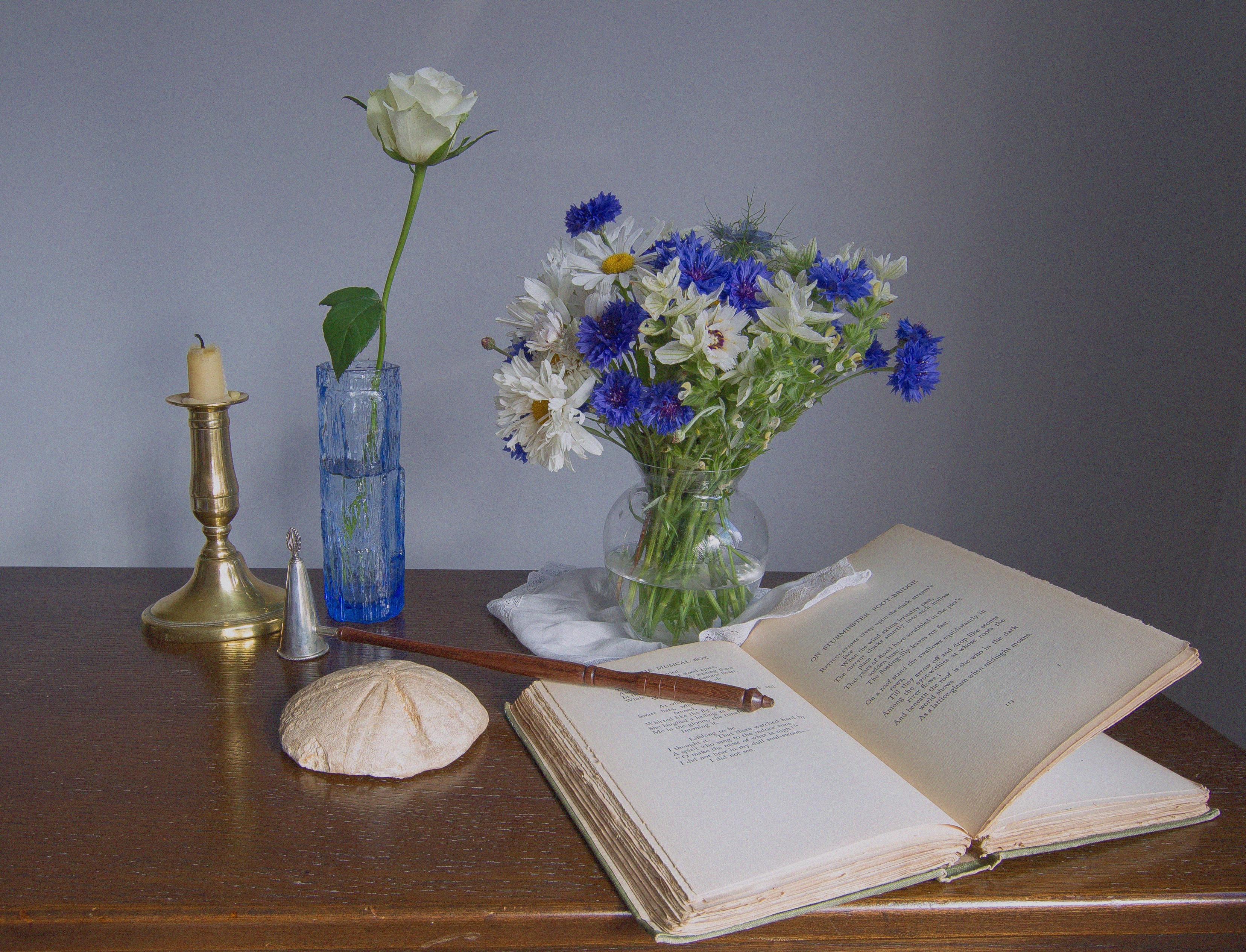 Still life with rose, wildflowers, candle, and book HD Wallpaper
